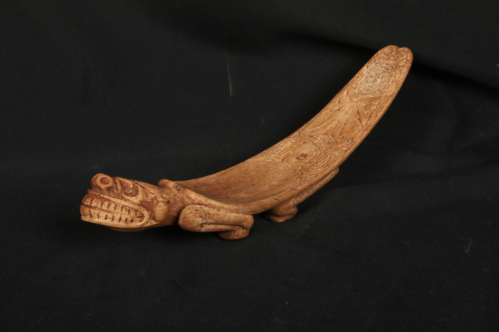 Pre-Columbian Bone Duho - Taino: A small manatee bone Duho, Taino culture with Zemi face on front, inscribed design on top rear, standing on four feet on reverse with male organ. 10-1/2" L x 2-1/4" W Provenance: Ex collection, N.J.;