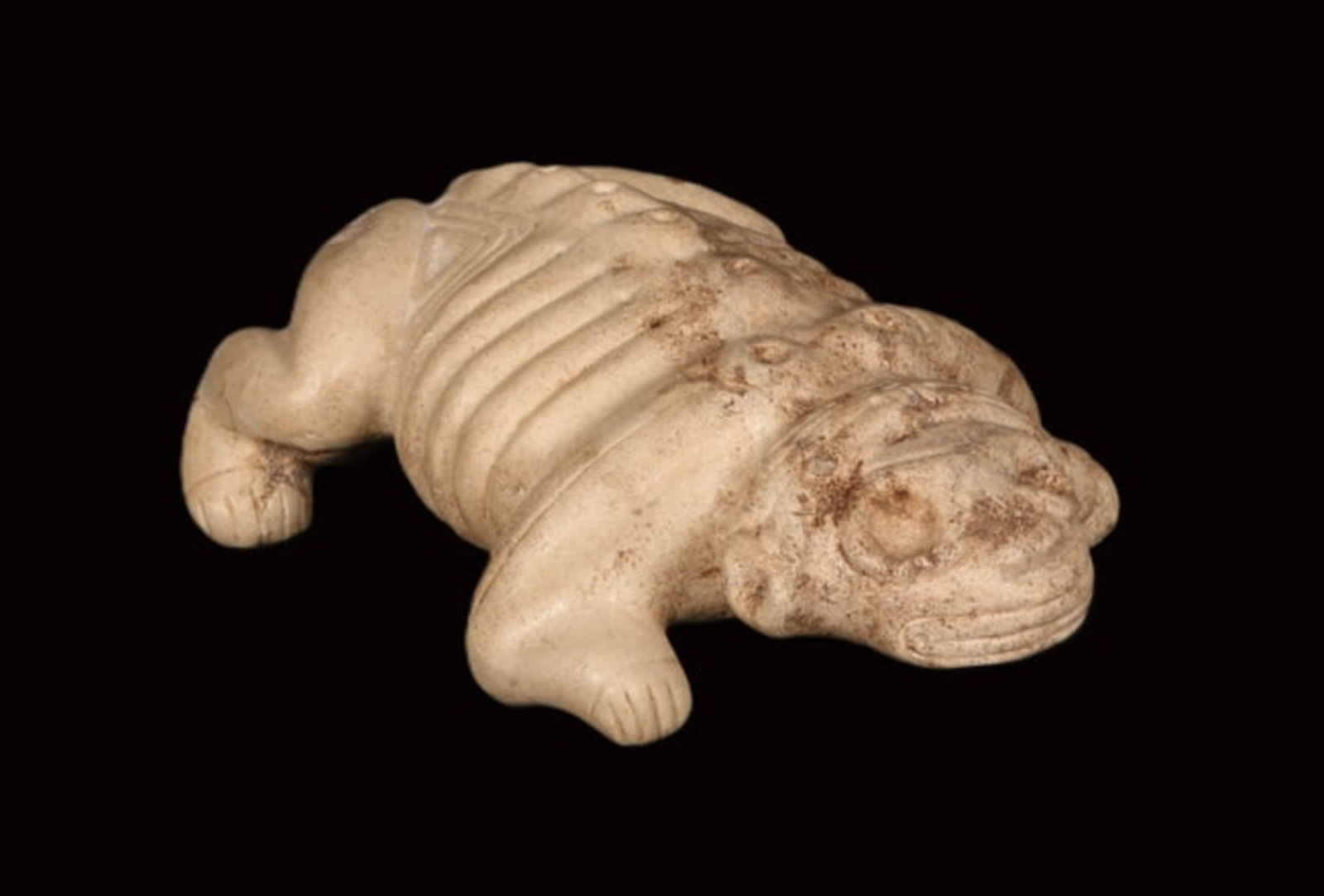 Pre-Columbian Taino Zoomorphic Zemi: A stone carved Zemi in shape of a zoomorphic creature with remains of encrustation. 9" L x 8" W x 3-1/2" H. Provenance: Ex collection, New Jersey, Ex. P. Bringuier, France acquired from P. Fayet, Pari