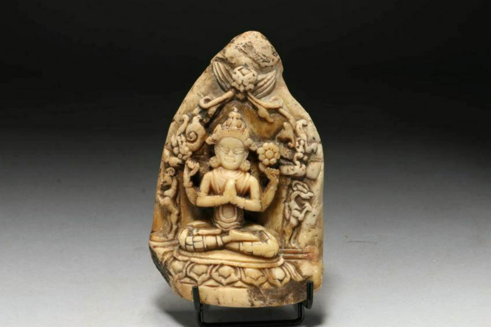 Tibetan Carved Stone: A ornate carved stone of Chenrezig. Old carving, possible 15th century, with export stamp on reverse. 5" x 3-1/4", 15 oz. Provenance: Ex private collection, MA