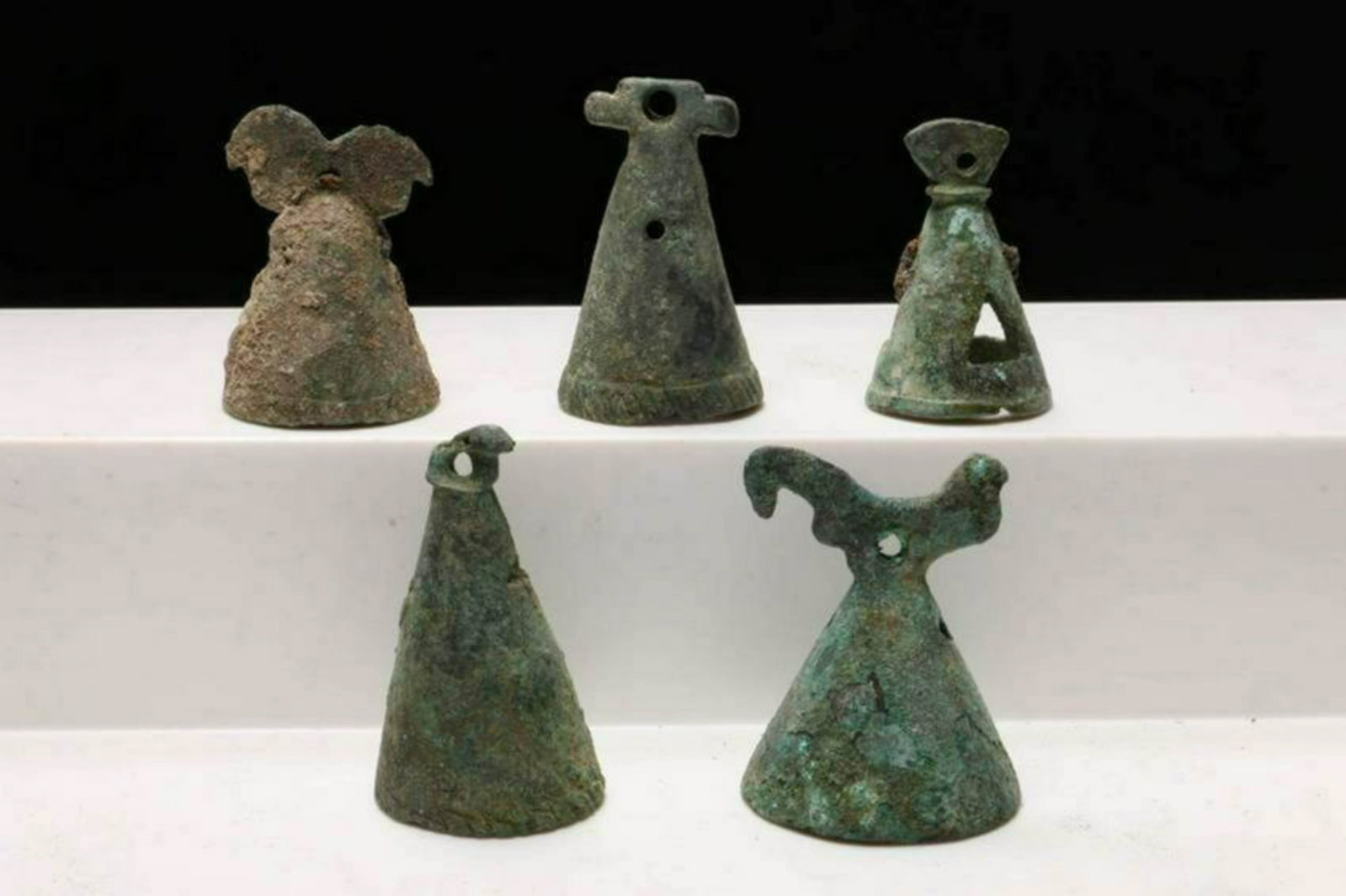 Luristan Bronze Bells: Five bronze Luristan bells, some with animal finials, nice patina and encrustation. One open cage. Dimensions: Approx. 1" - 1-1/2"H Provenance: Ex. V. Funiciello collection, Brooklyn, NY