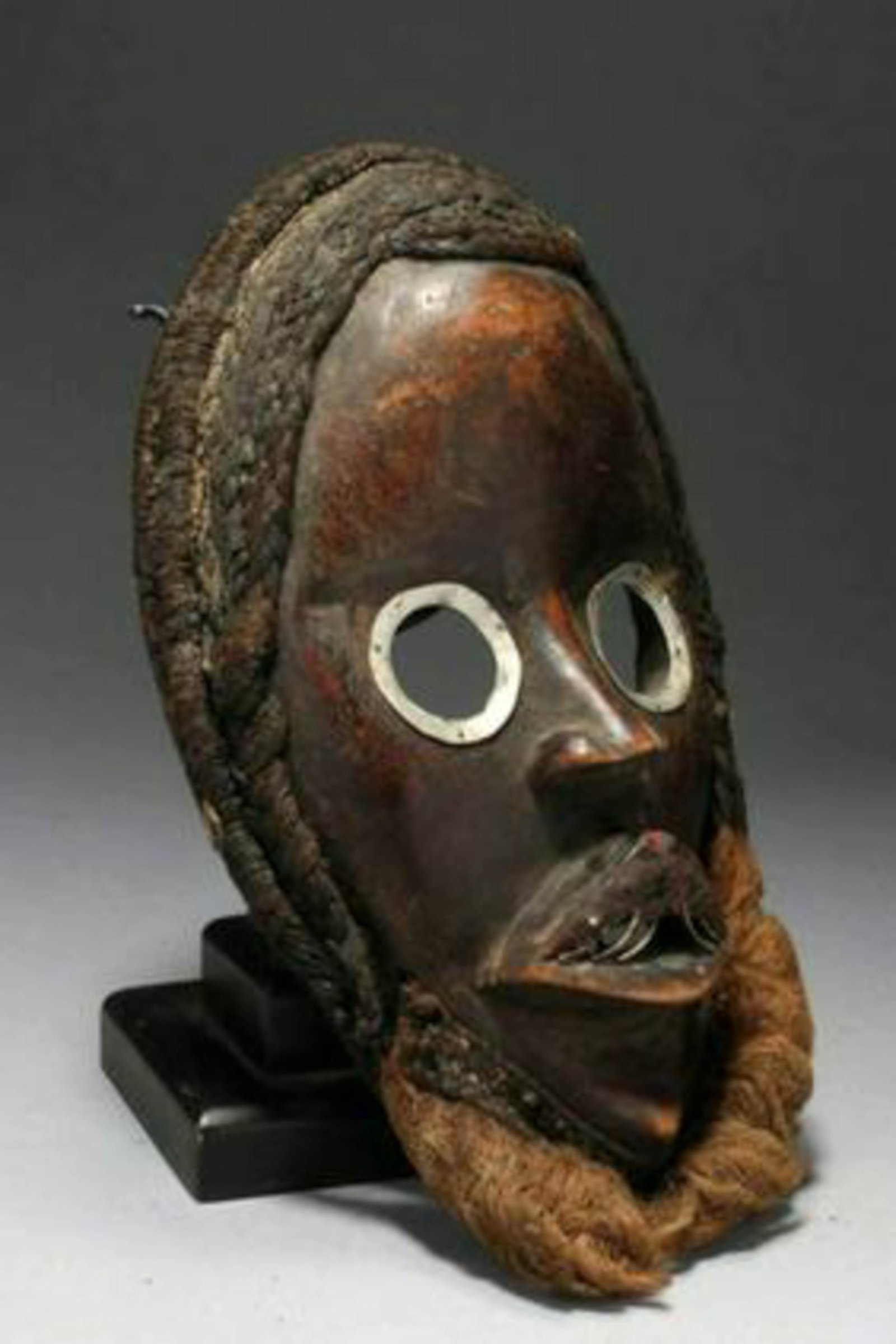 African Art Dan Mask: Dan mask, Ivory Coast, with metal eyes, teeth, fiber for hair and beard. Mid-20th century. 10-3/4" H; 8.5 oz. Provenance: Ex. D. Parcas collection.