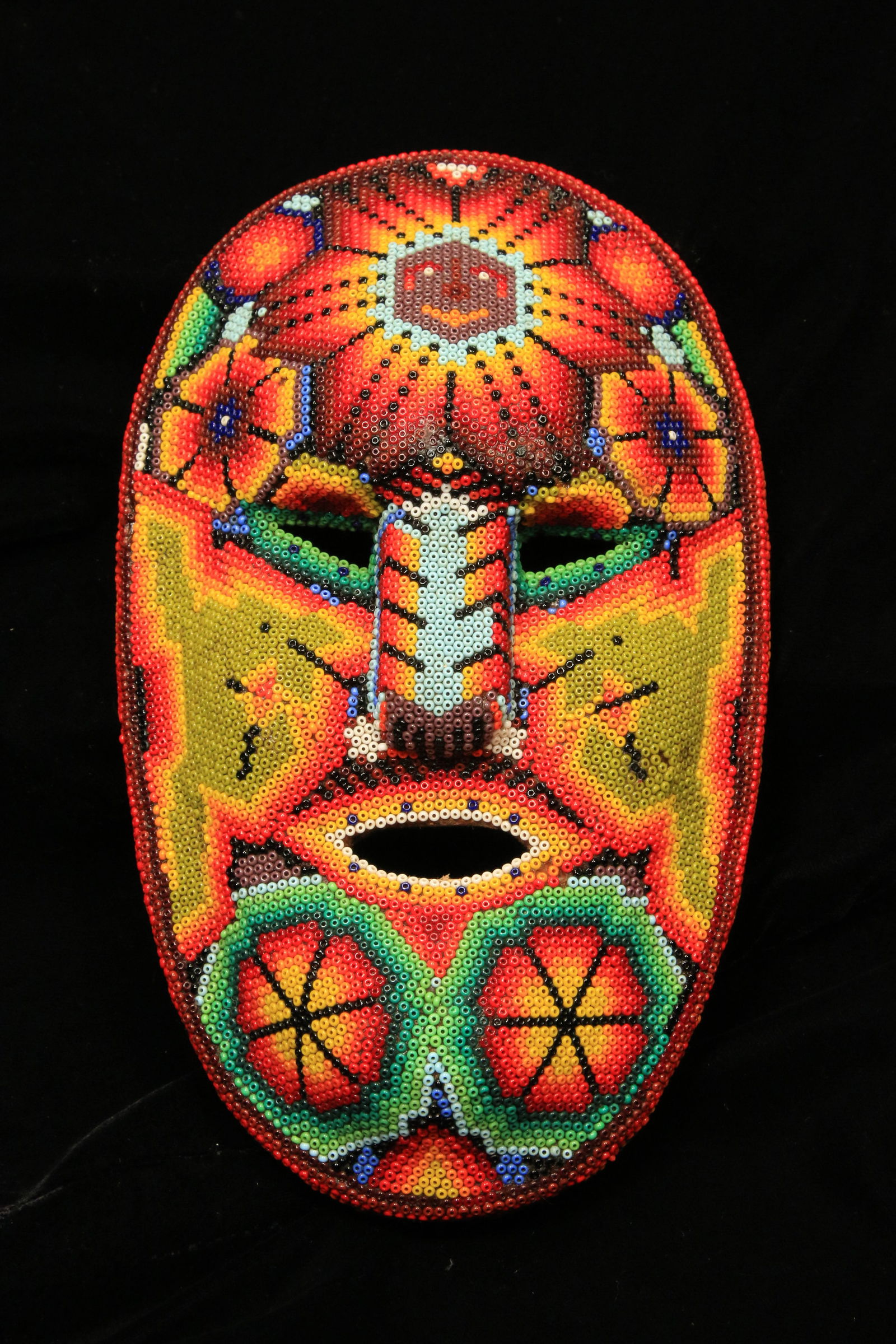 Native American Huichol Mask: A wood beaded mask with classic Huichol designs. 8" H. Contact Auction House for discounted in-house shipping quote