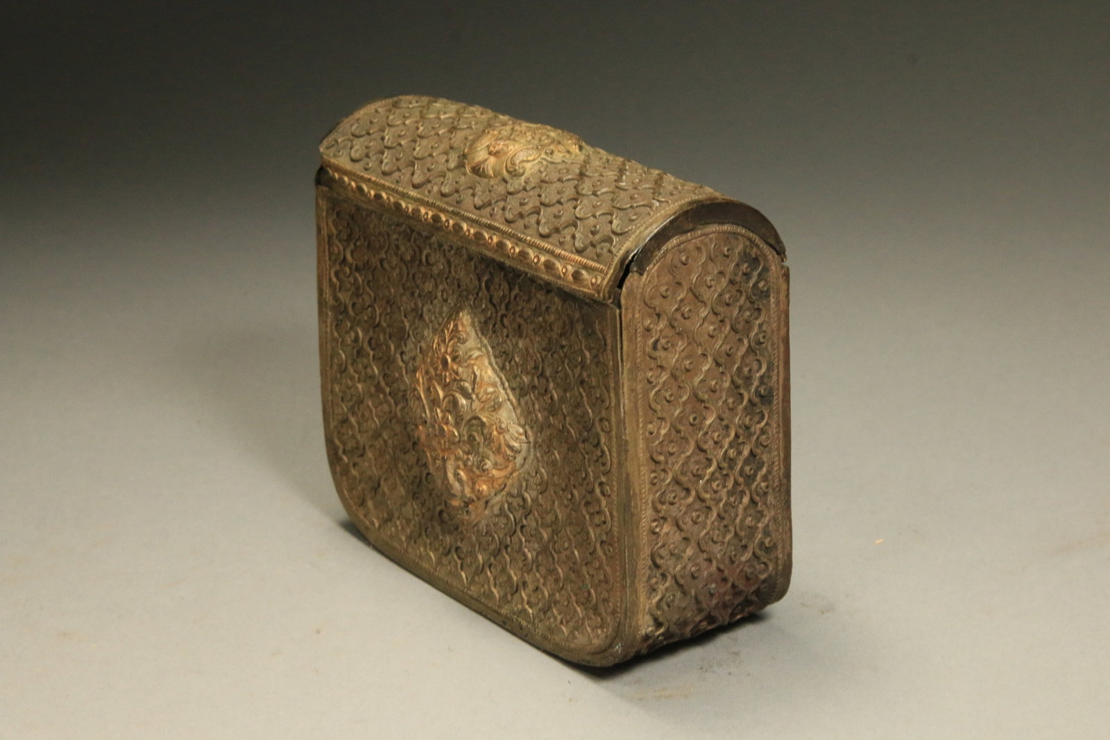 19th Century Ottoman Brass Cartridge Container: A cartridge container with foliage design, belt loops on reverse.