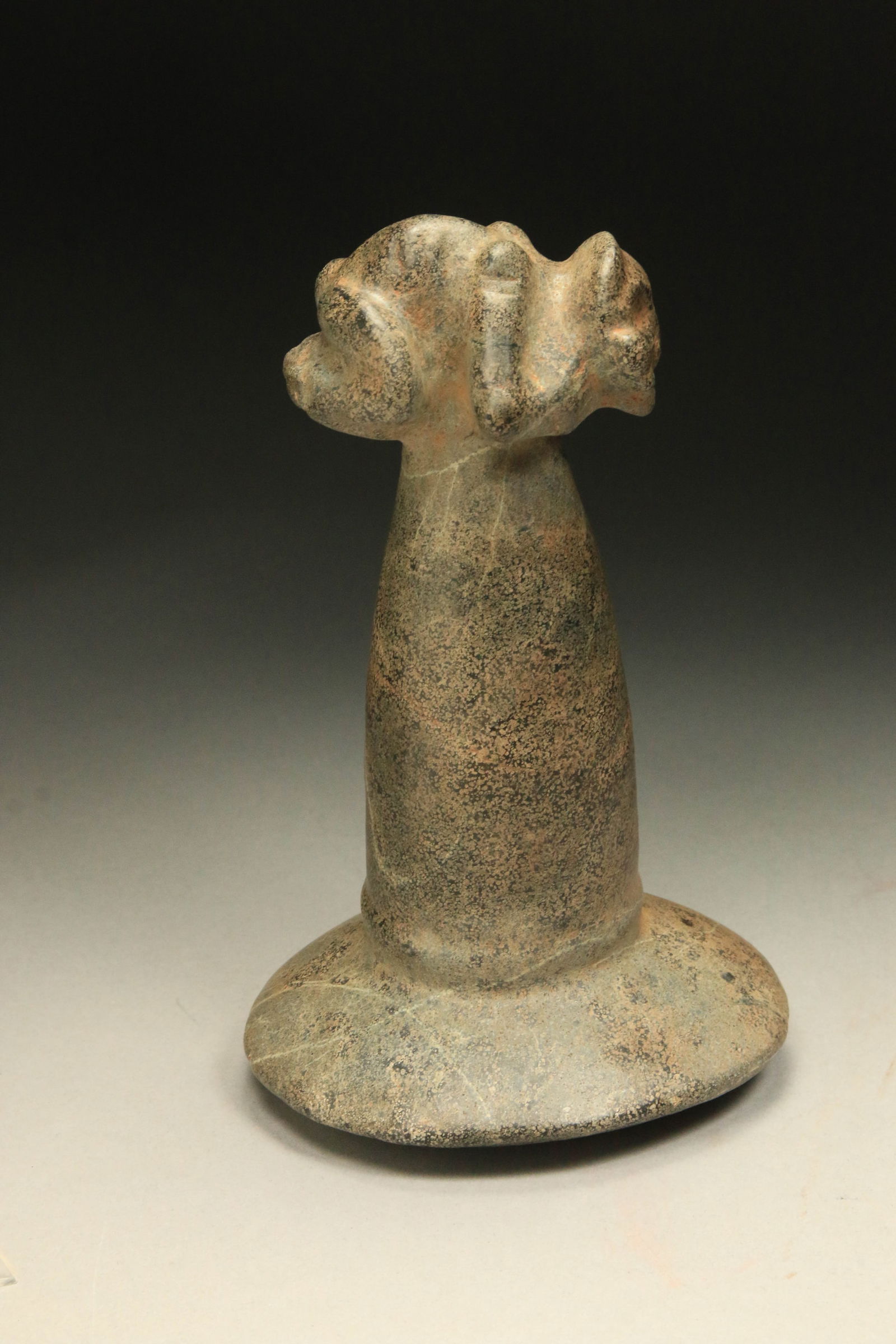 Pre-Columbian Taino Pestle: A large carved stone Taino pestle with zemi figure finial with a large pounding base with a fluted shaft. 7-3/4" H. Provenance: Ex collection D. Parcas, New York, NY. The primary function of this type