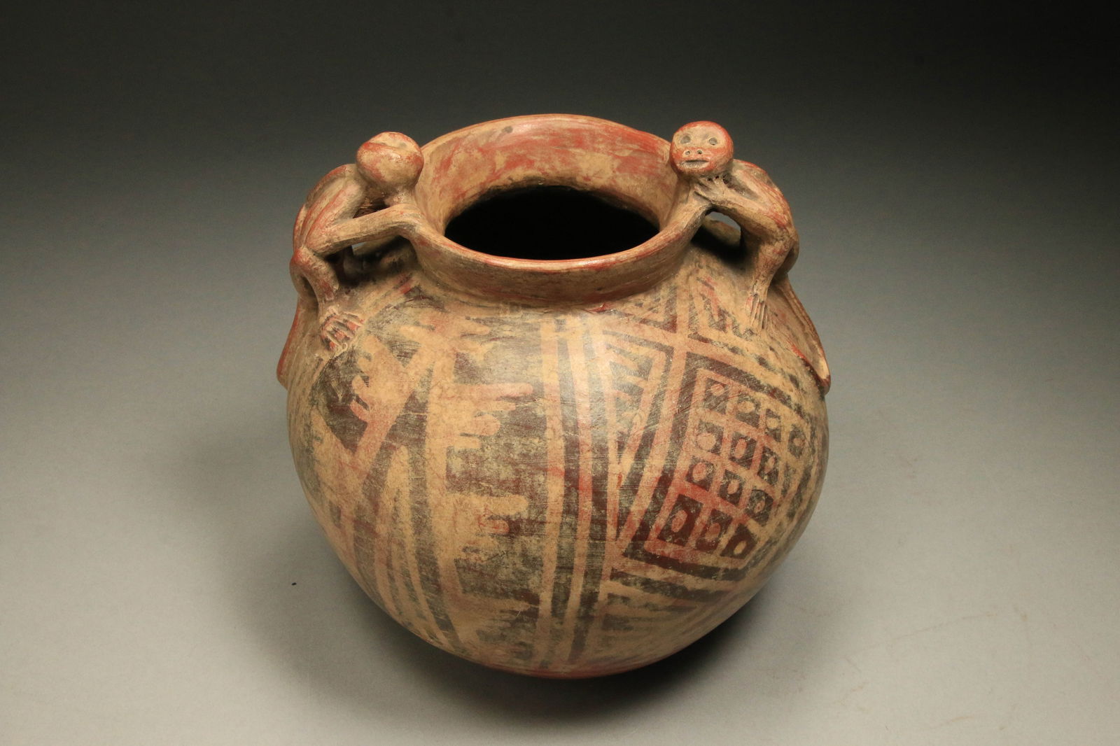 Pre-Columbian Monkey Bowl: A Narino pre-Columbian monkey bowl with negative resist abstract design, two monkeys with long tails at rim as handles. 7-1/2" H x 8" W.