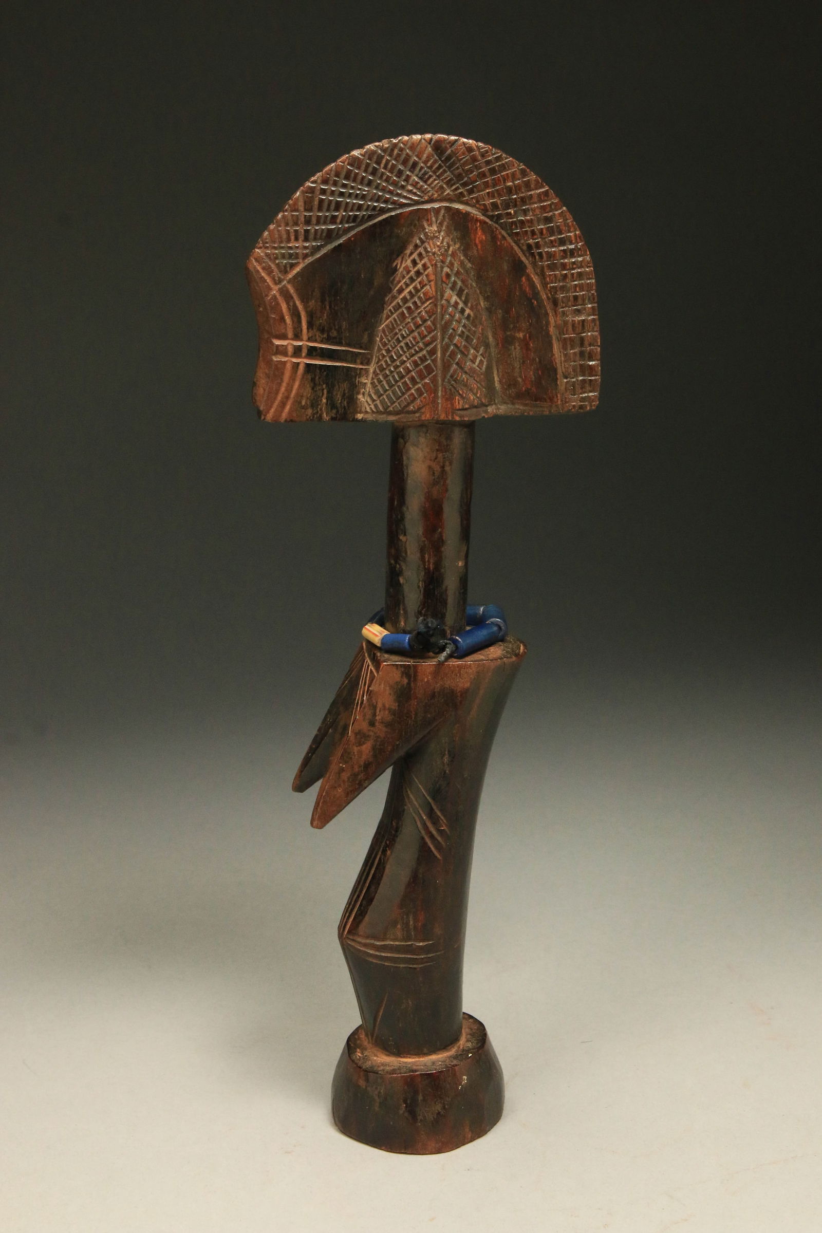 African Art Mossi Doll - Burkina Faso: A Mossie biiga fertility figure from Burkina Faso.. A wood doll with an incised abstract head, long neck, pointed breasts, torso extending to a pregnant swelling belly. Old beads around neck. 11-3/4"