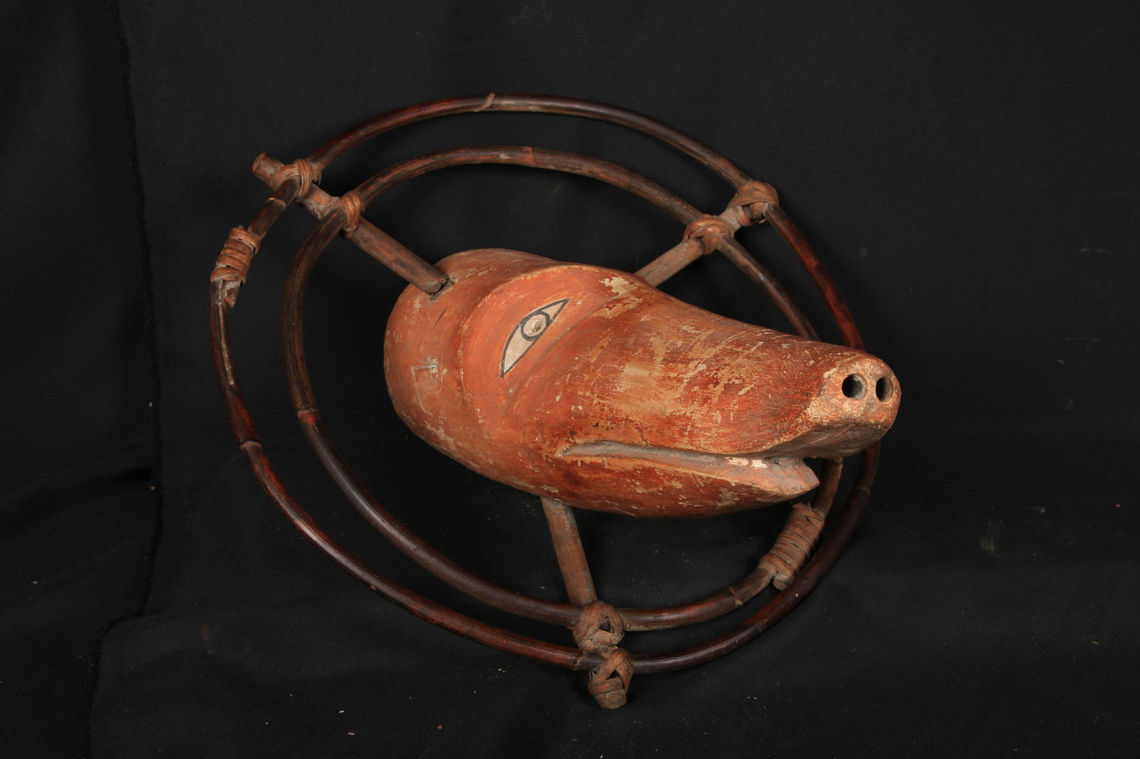 Inuit Spirit Mask: A Yup'ikl spirit mask representing a boar, with long snout. The mask features outer wooden rings, or "universe rings. These masks were traditionally used in ceremonial dances and rituals, often by sha