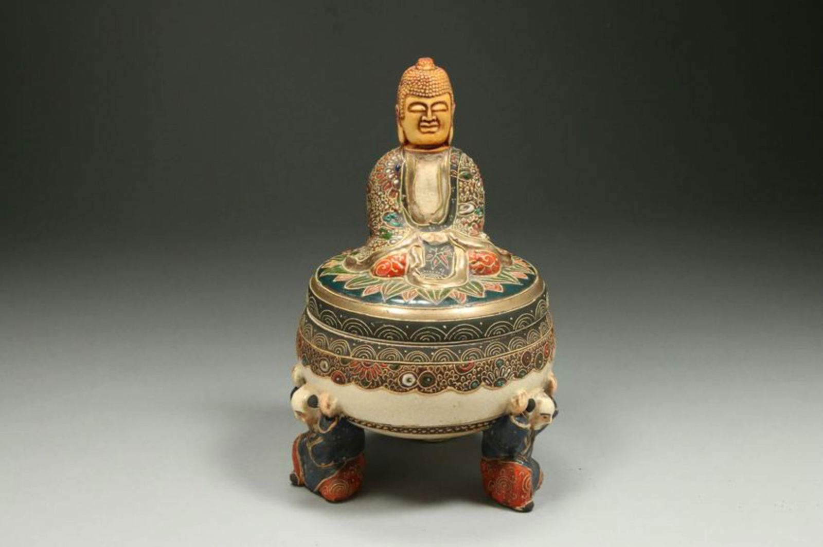 Japanese Porcelain Bowl with Buddha lid.: A small covered bowl with tripod figurine legs, Buddha lid. Marked : Made in Japan". 5" Dia. X 7-1/2" H