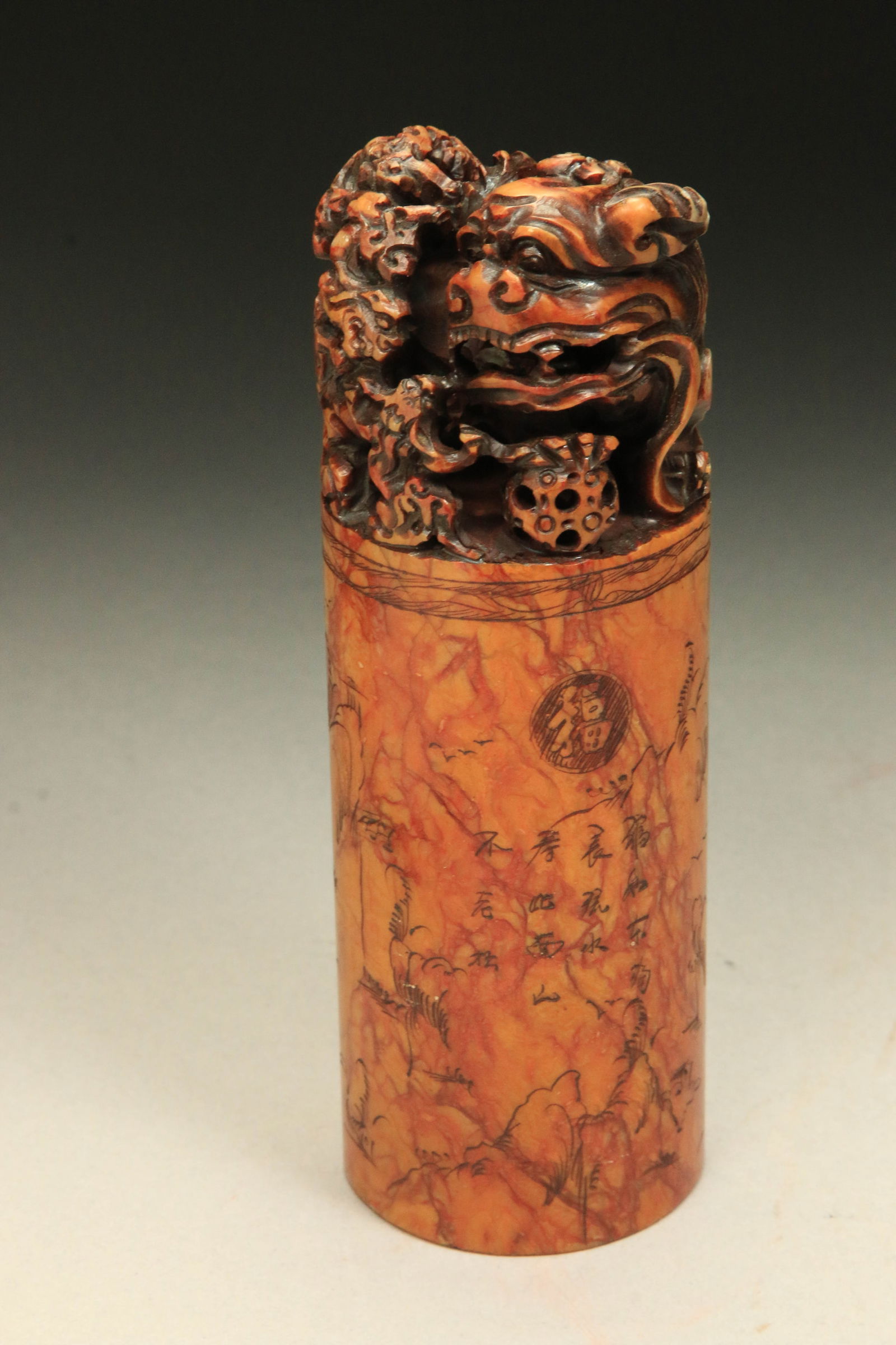Antique Vintage Chinese Shoushan Stone Carved Seal Stamp: A large Shoushan stone seal with foo dog finial. The cylindrical body is engraved with Chinese characters and a landscape scene. The bottom surface of the seals is a traditional seal script with remai