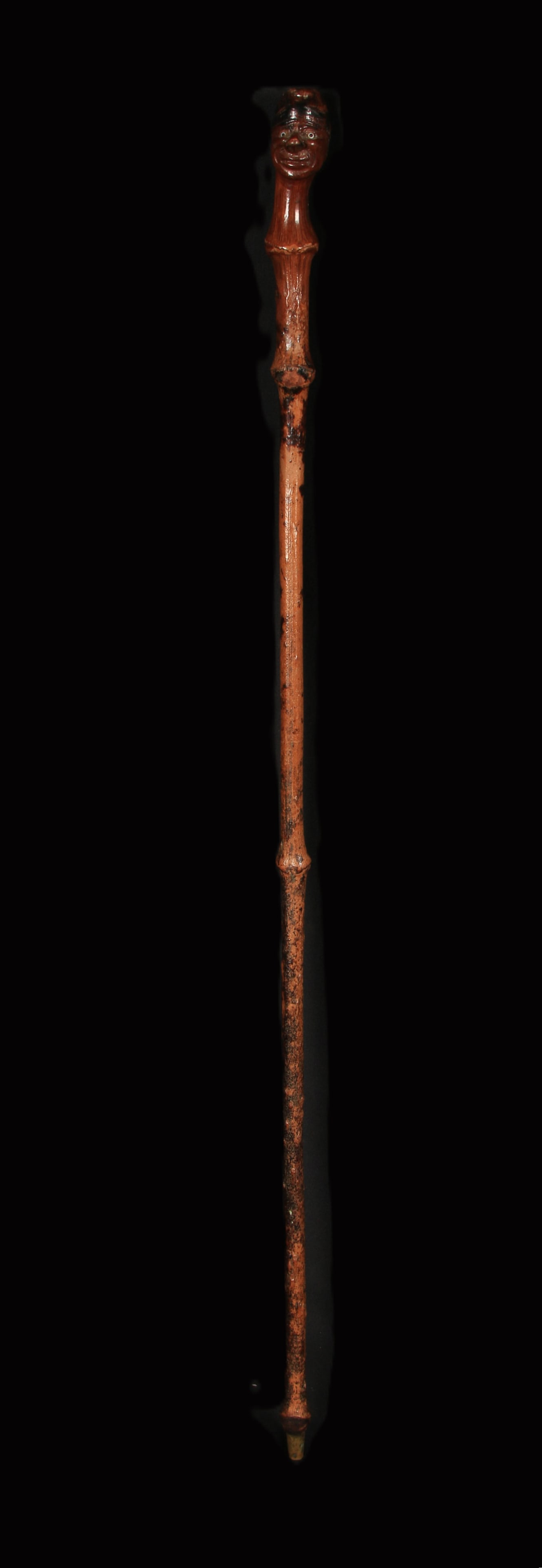 Fok Art Wood Cane: A carved wood cane with head wearing a cap, long nose and glass eyes, "Mr. Snouty". 32" L.