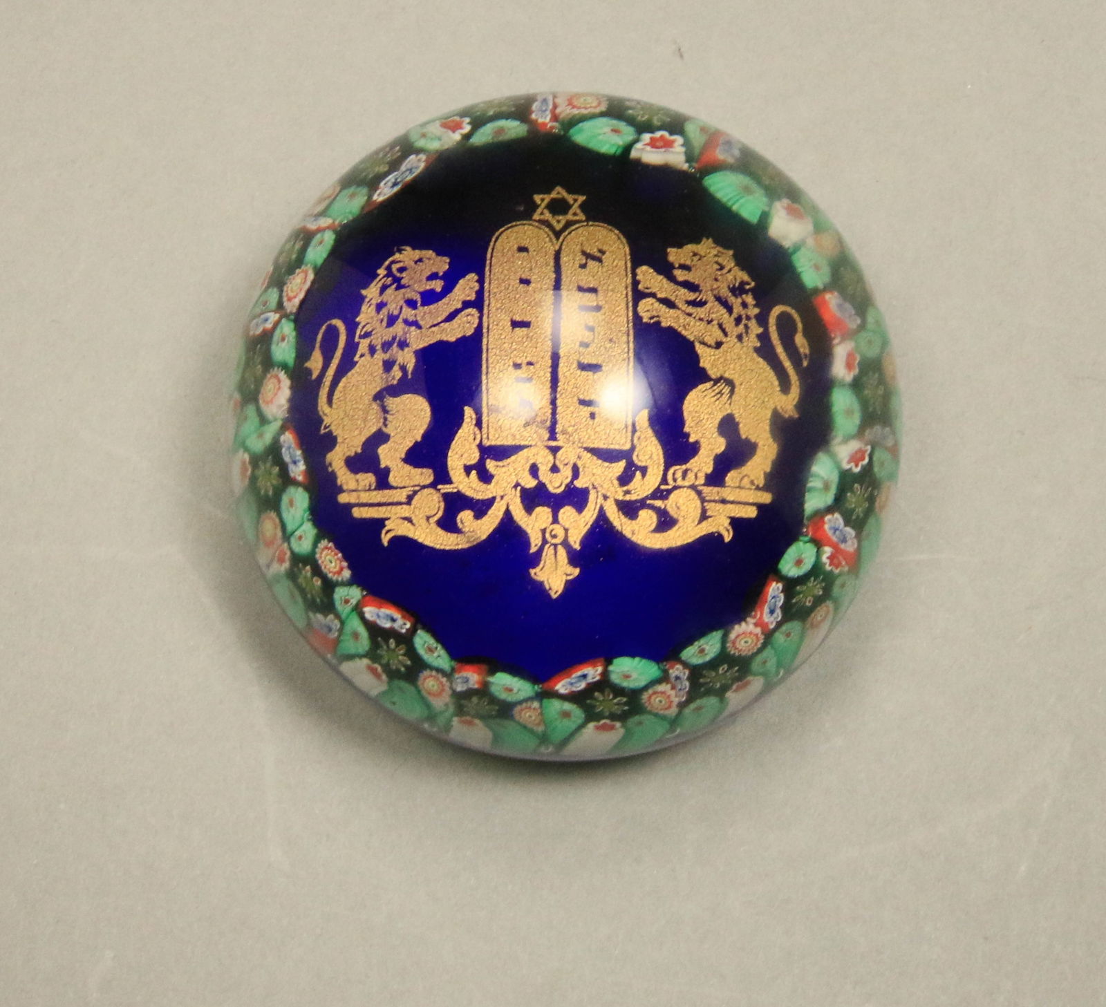 Vintage Murano Glass Millefiori Paper Weight: Vintage Murano glass Millefiori border gold tone Ten Commandments Lions, Star of David Judaica Jewish theme round blue paper weight. Signed on bottom. 3" L.