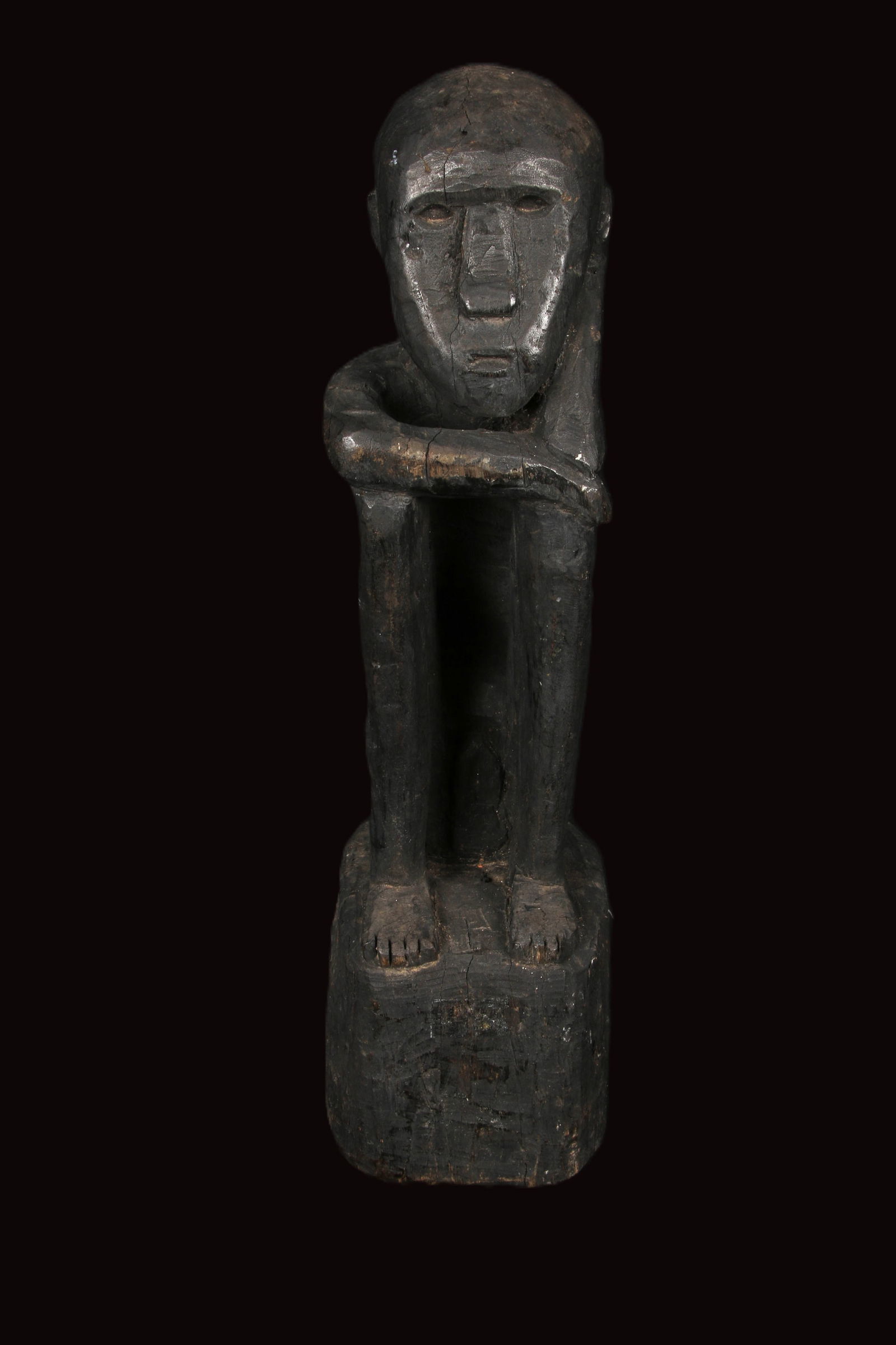 Philippines Bulul Guardian Statue: A wood Bulul Rice God, Ifugao, Statue is seated with bent knee posture. Crossed arms resting on knees 17" H. These figures act as rice gods or guardian spirits, believed to ensure a good harvest and p