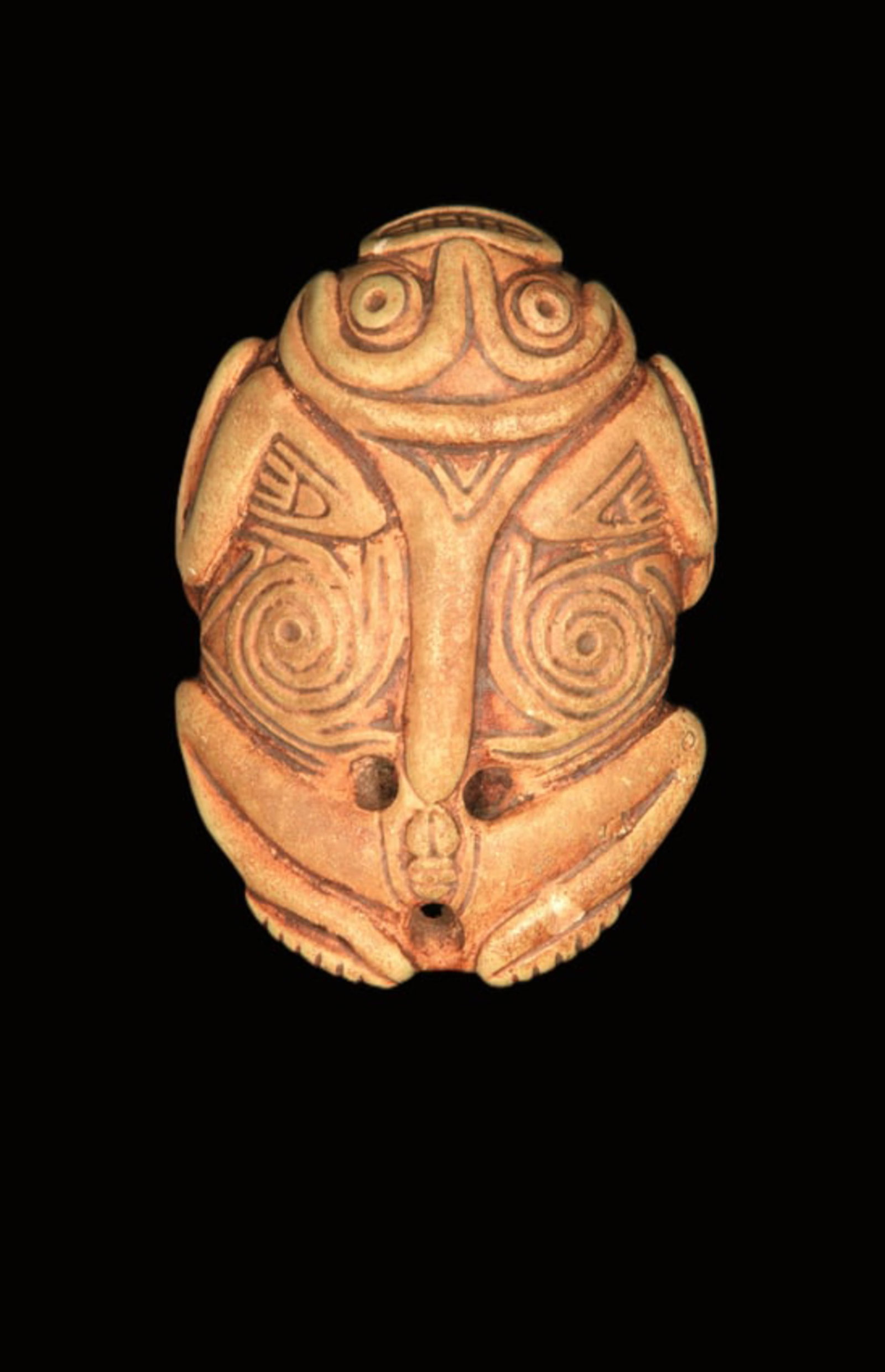 Pre-Columbian Taino Amulet: A stone anthromorphic amulet in the shape of a frog with large eyes, toothy mouth, scrolling design on top and bottom. 3.5" L. Provenance: Ex Tony Milton, NM.
