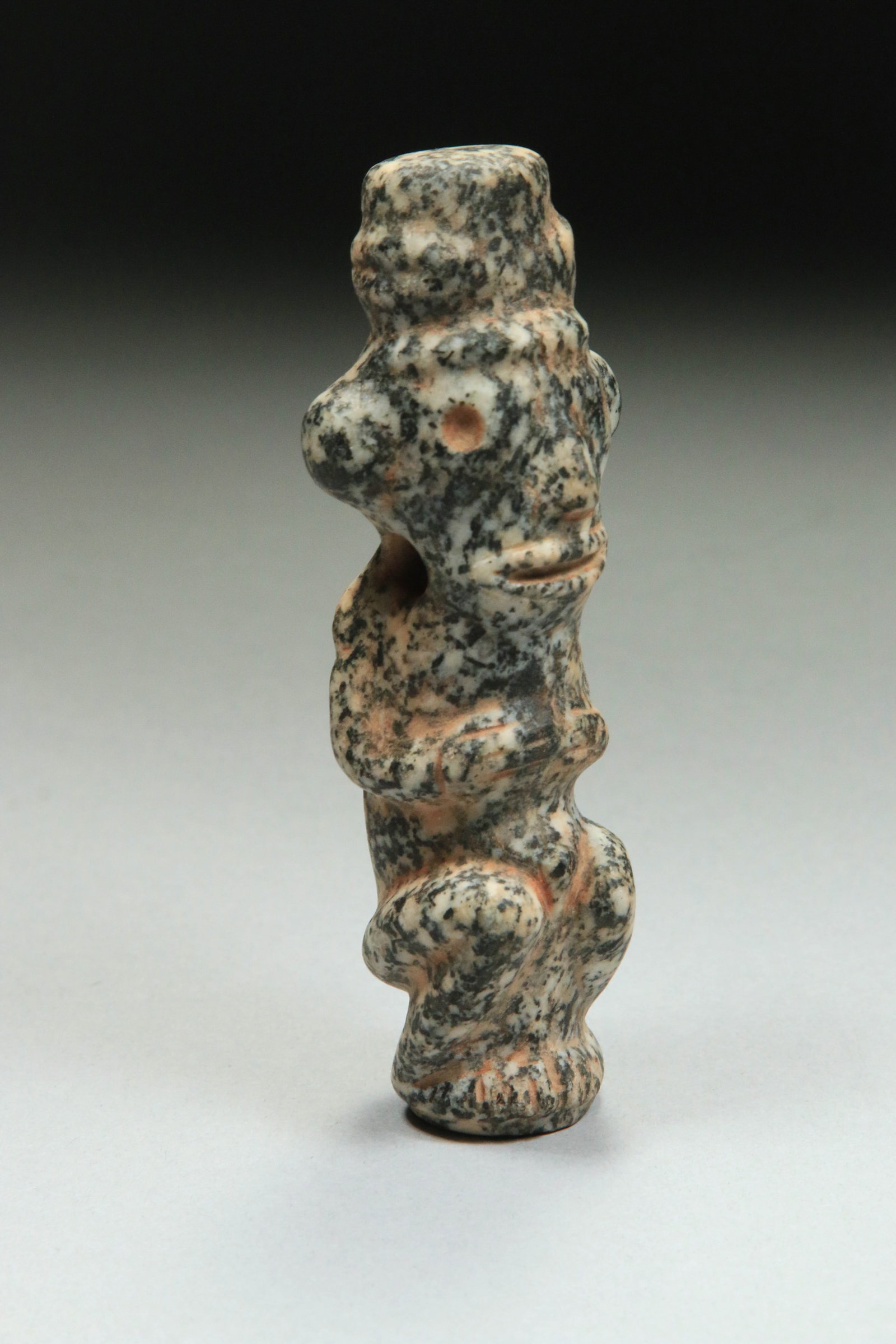 Pre-Columbian Taino Zemi: A speckled stone Zemi amulet with anthromorphic Zemi. 4-1/2" H. Provenance: Ex collection, New York, N.Y.