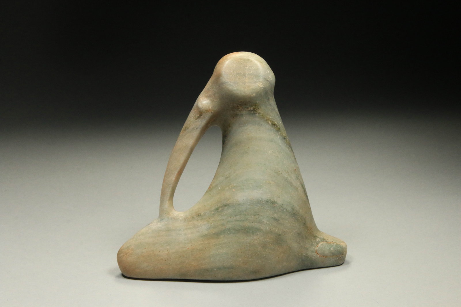Pre-Columbian Pelican Tri-pointer: A cream colored carved stone of a pelican tri-pointer. 6-1/2" L. Provenance: Ex collection D. Paracas, New York, N.Y.