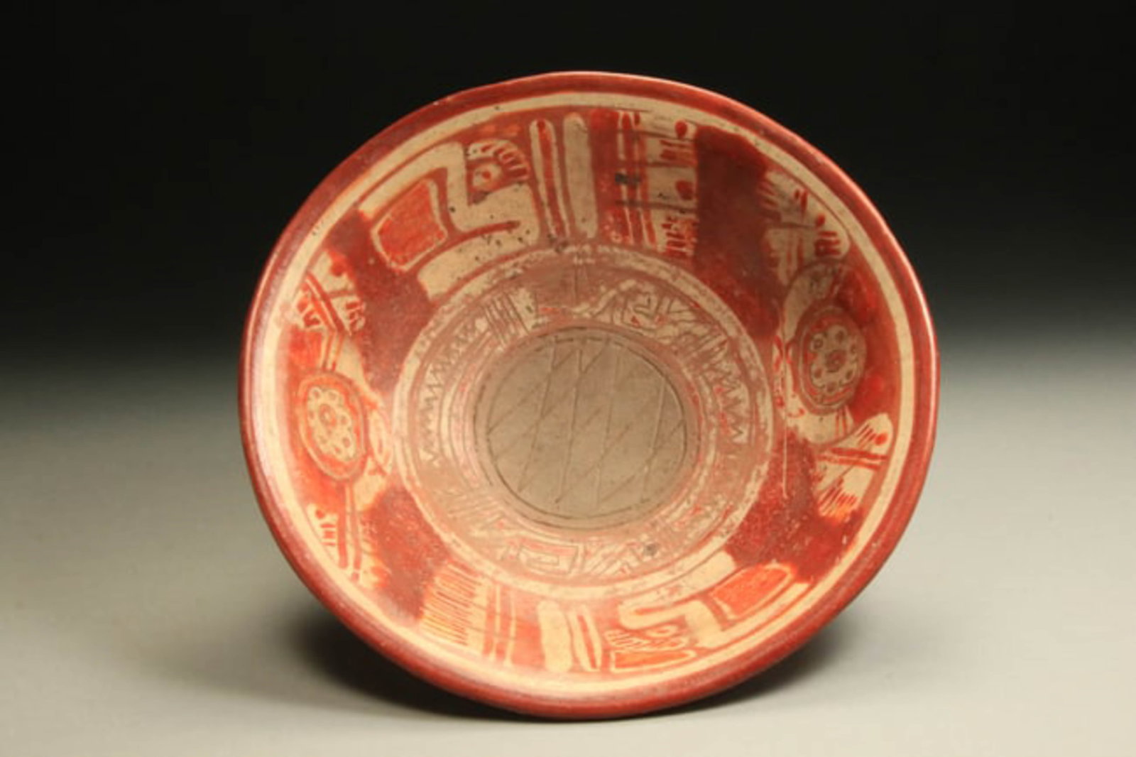 Pre-Columbian Michoacan Bowl: A large decorated bowl standing on rattle tripod legs. Center roundel with incised hatching. Floral design with abstract profile of birds. 13" L x 3-1/2" H. Provenance: Ex. Collection, Dr. D. Harner,
