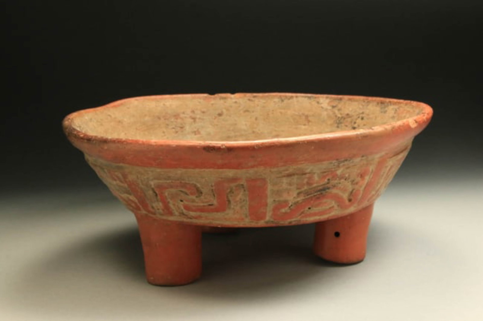 Pre-Columbian Mayan Tripod Bowl: A large Mayan tripod bowl with wide exterior band of relief geometric elements. 10" x 4". Rattle feet. Provenance: Ex. Scheifele Collection, CT, acquired in the 1960's.