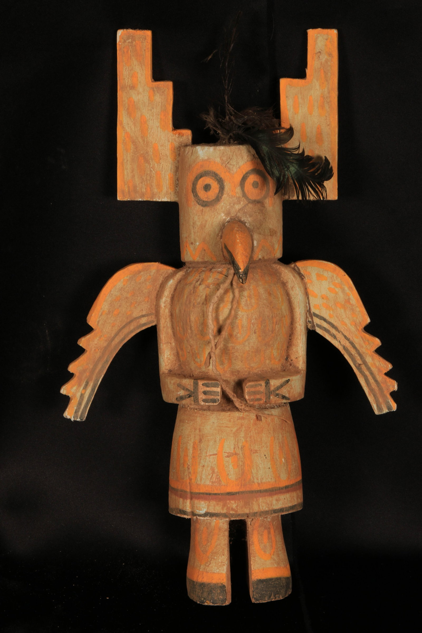 Native American Katsina Doll: Hopi Katsina doll, likely representing a bird spirit such as an eagle or owl, crafted from carved wood and painted with traditional pigments, feather at head. 14-1/2" H. Provenance: Ex. Collection Ped