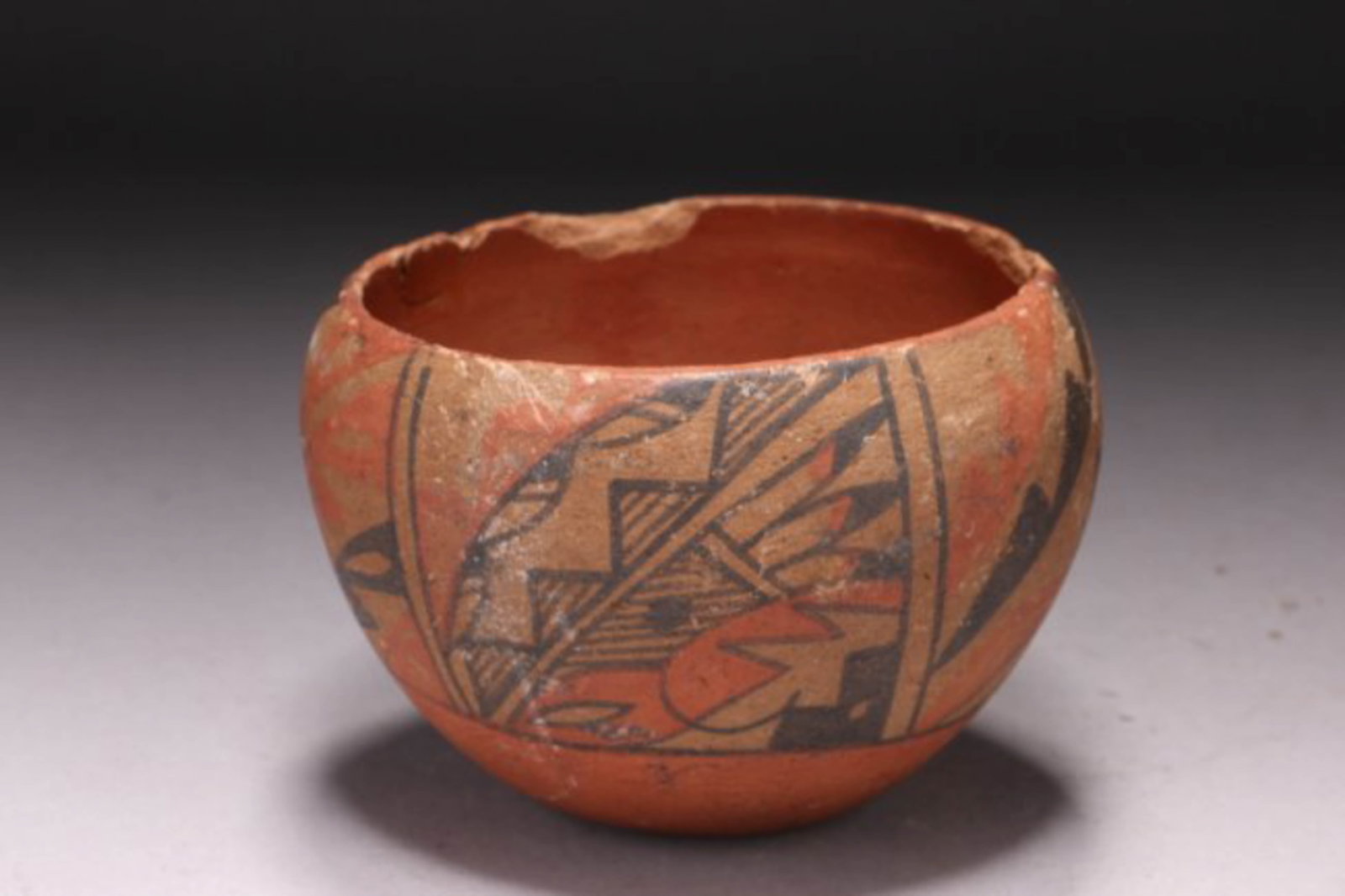 Early Native American terracotta Bowl: Native American Bowl, low fire, with four registers of design, including feather, mountains, cliffs, and stylized bird. Flat bottom. Dimensions: 3-1/4" H; Weight:13 oz. Provenance: Private collection,