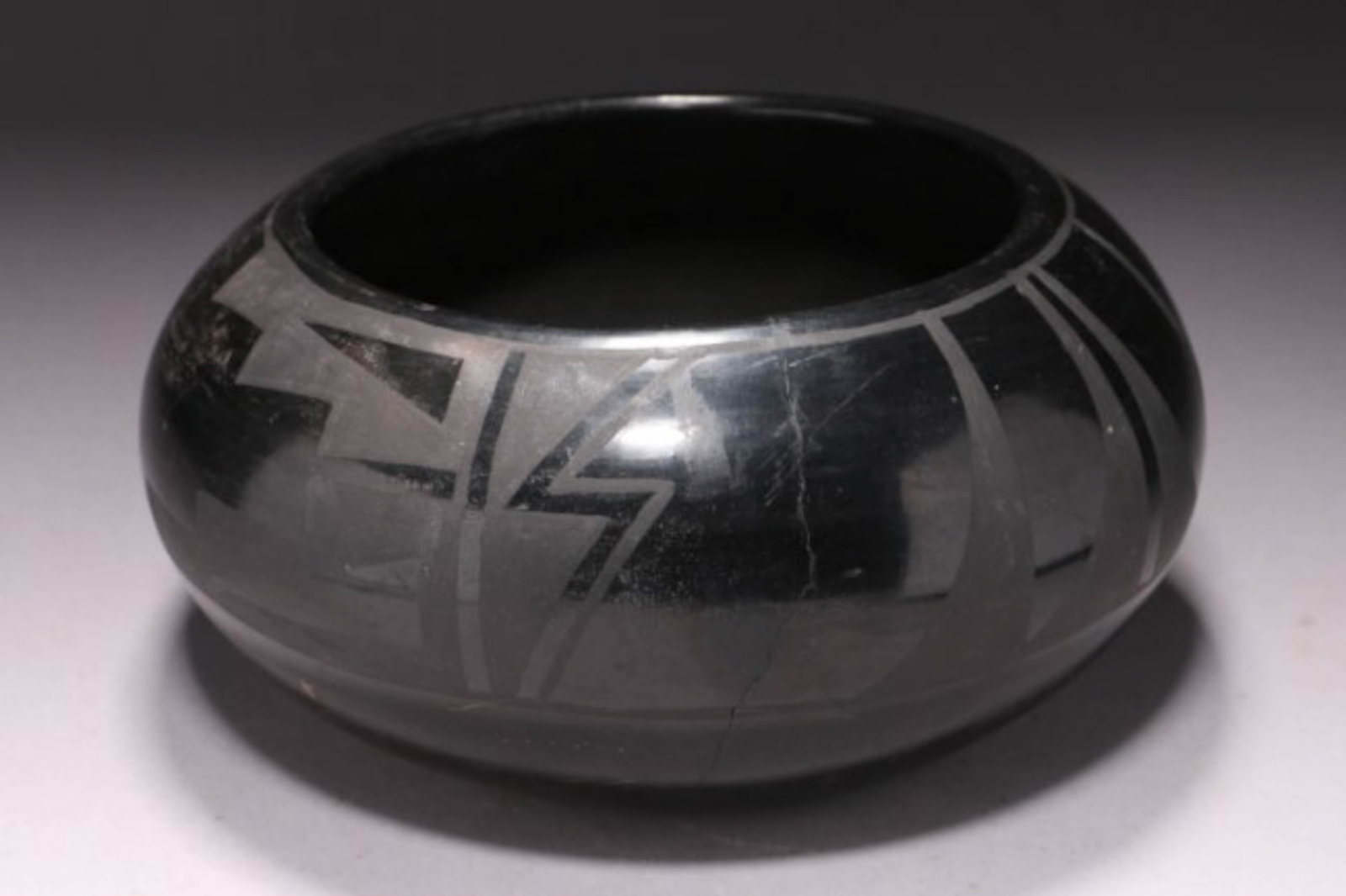 Native American Ceramic Black ware Bowl: Large bowl with low mat glaze design. Dimensions: 8-1/2" Dia.; Weight: 2 lbs. 13 oz.