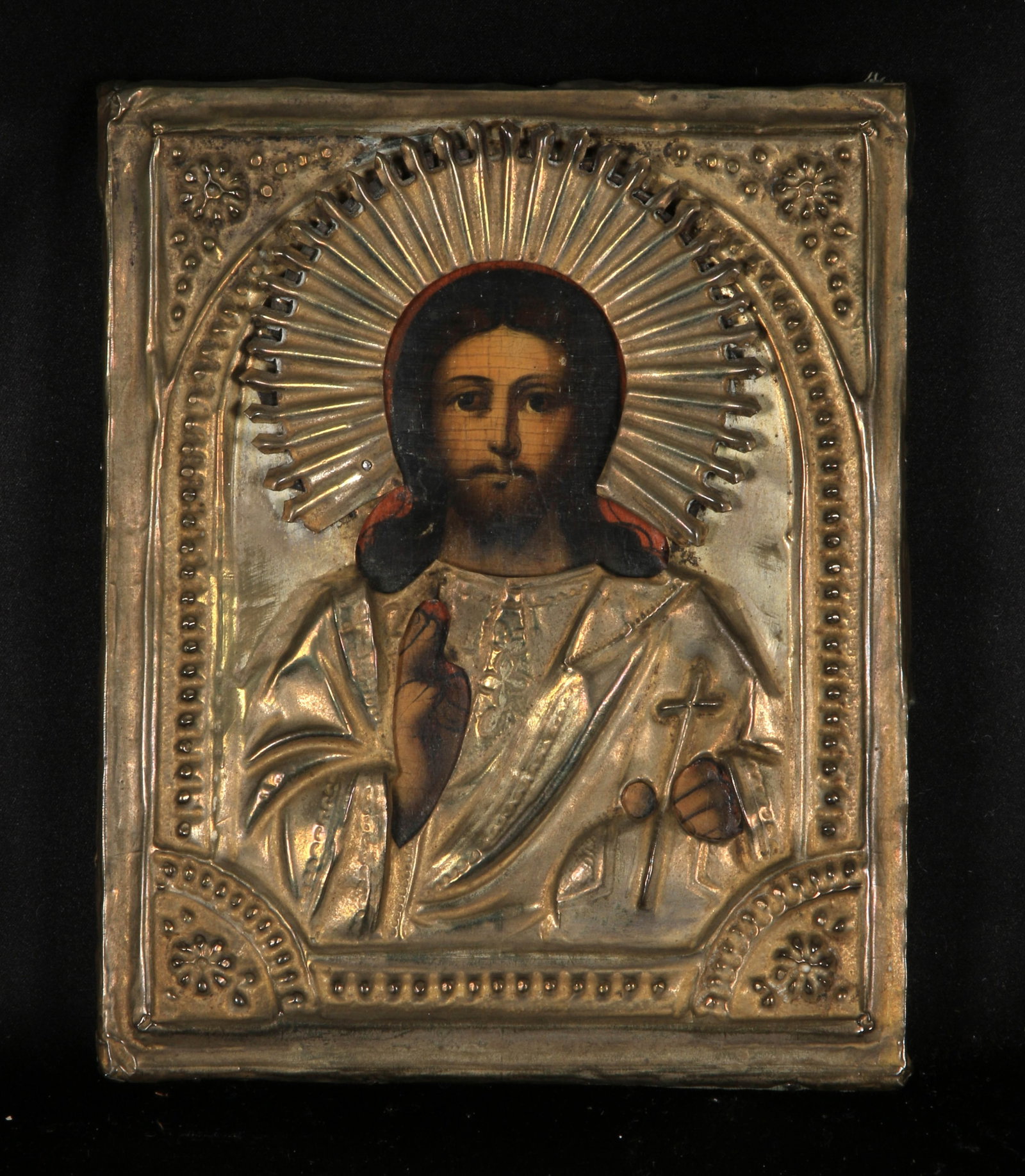 19th Century Russian Icon: 19th-century Russian icon of Christ Pantocrator. It features a hand-painted depiction on a wood panel, overlaid with a metal cover known as an oklad or riza. The icon portrays Jesus Christ as the "Rul