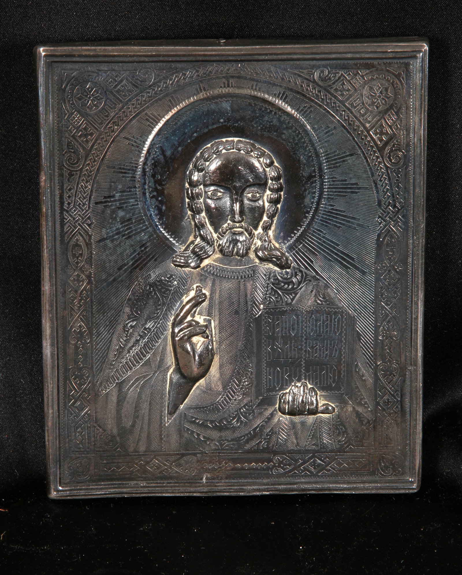 Pure Silver Russian Orthodox Icon of Christ Pantocrator: Pure silver Icon depicting Christ holding a Gospel book in his left hand and making a blessing gesture with his right. The metal cover, known as a riza or oklad is pure silver marked "999". 5" x 4-`/4