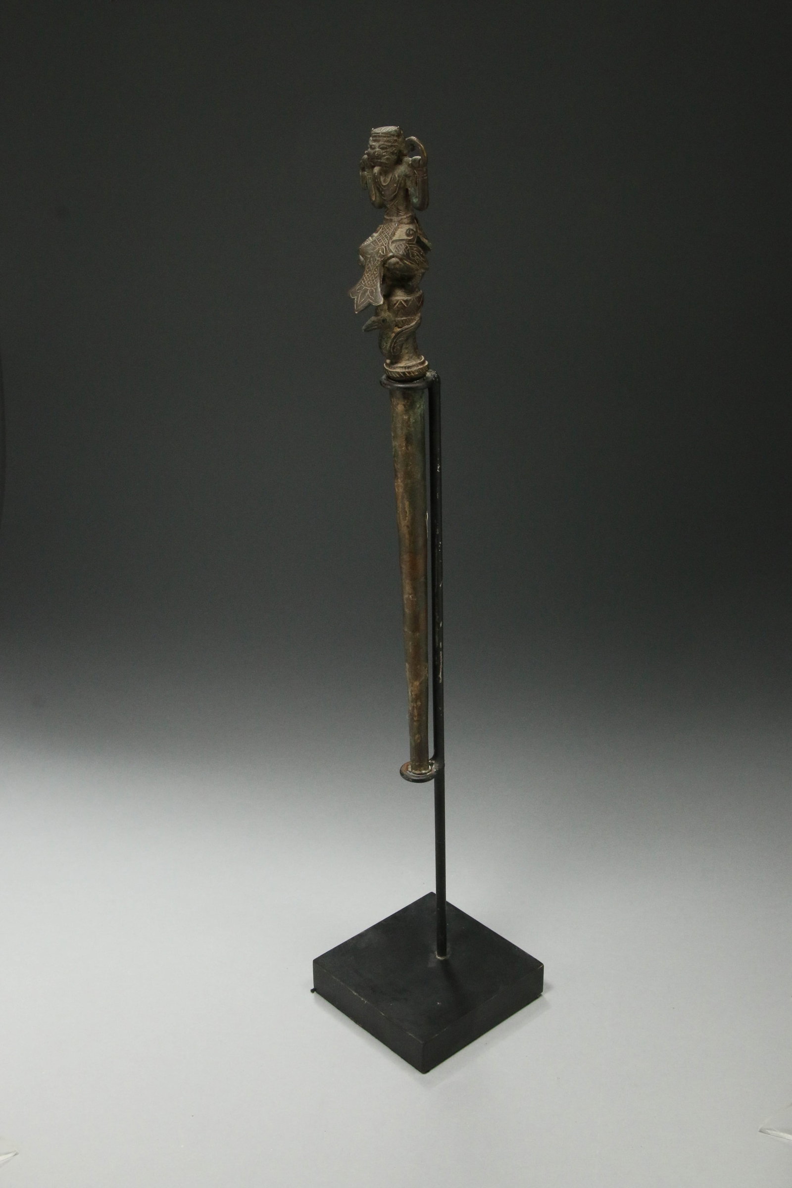 Indonesian Bronze Calligraphy Instrument: A bronze writing instrument with zoomorphic finial. Calligraphy point missing. Display stand included. 11" H