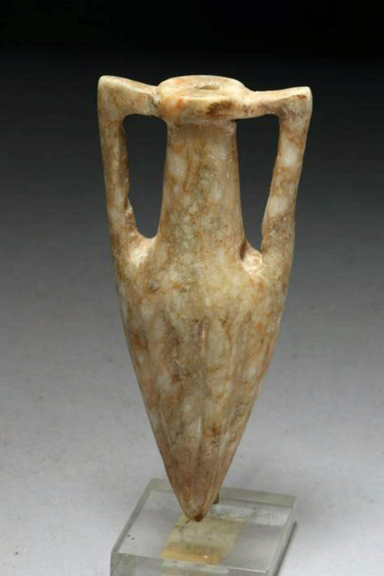 Ancient Hellenistic Marble Kohl Vessel: A 3rd century B.C. marble kohl vessel, amphora form, two handles. Tapered end. 5" L. Provenance: Ex. Zaddick, Jerusalem.