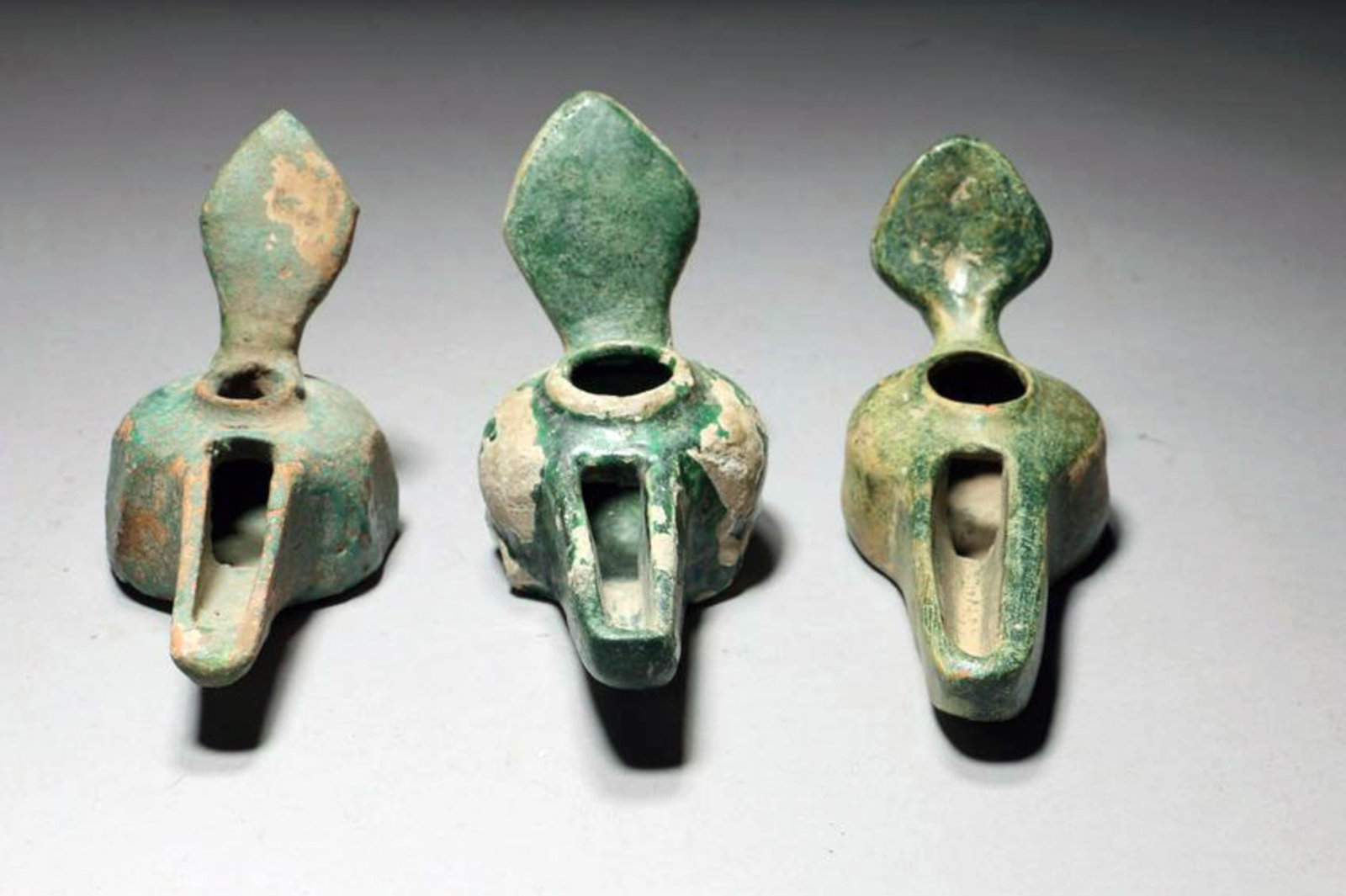 Middle East Oil Lamps - Lot of 3: Three Persian oil lamps. All with long wick spouts, loop handles with thumb holds. 5-1/4' L - 6-1/4" L Provenance: Ex private collection NYC