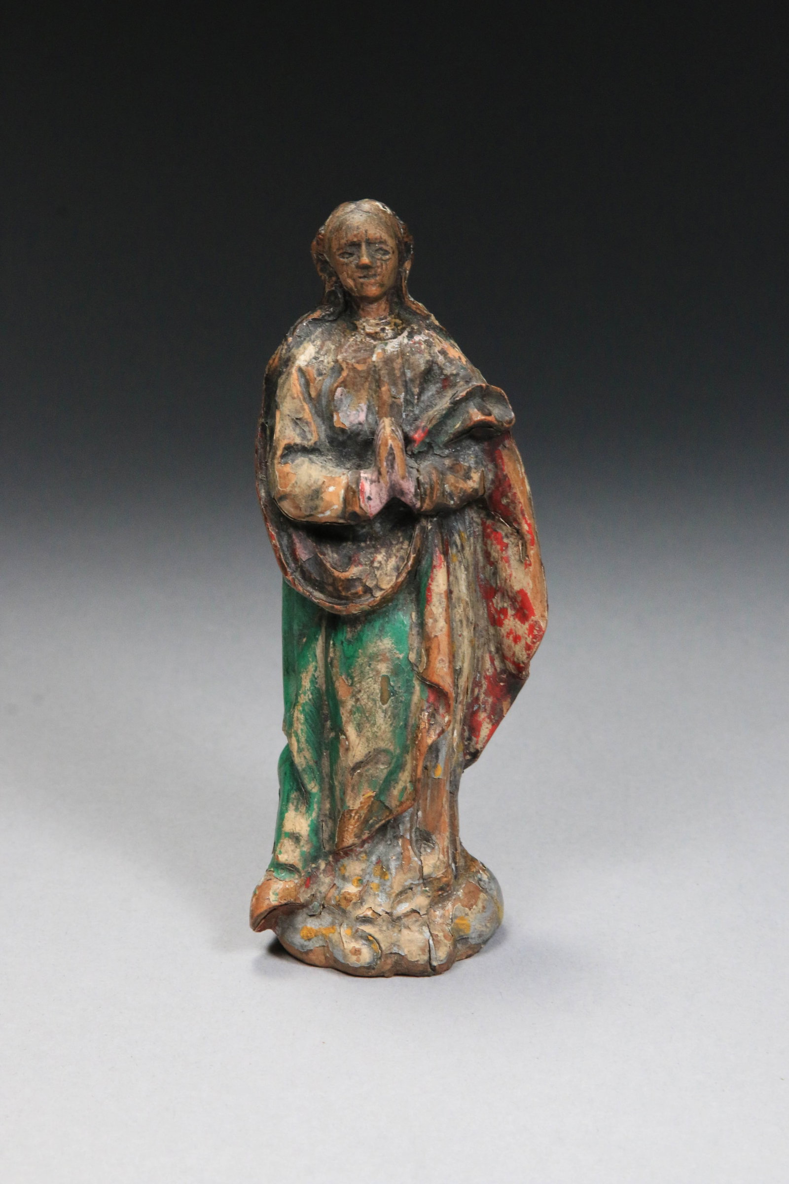 18th Century Spanish Colonial Santos: 18th-century Spanish Colonial Santos figure, the Virgin Mary in a prayerful pose. Carved wood with polychrome paint and gesso. These figures were typically used as devotional objects in homes or small