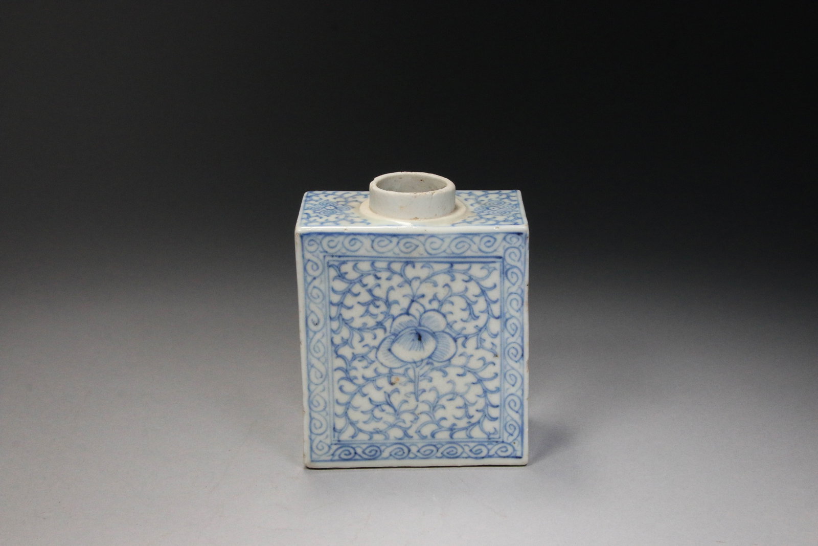 Chinese Blue and White Tea Caddy - 19th Century: Chinese blue and white porcelain tea caddy featuring a floral scroll design. The rectangular jar is decorated with a continuous underglaze blue floral scroll pattern on all sides. 8-1/2" H x 4-1/2" W.