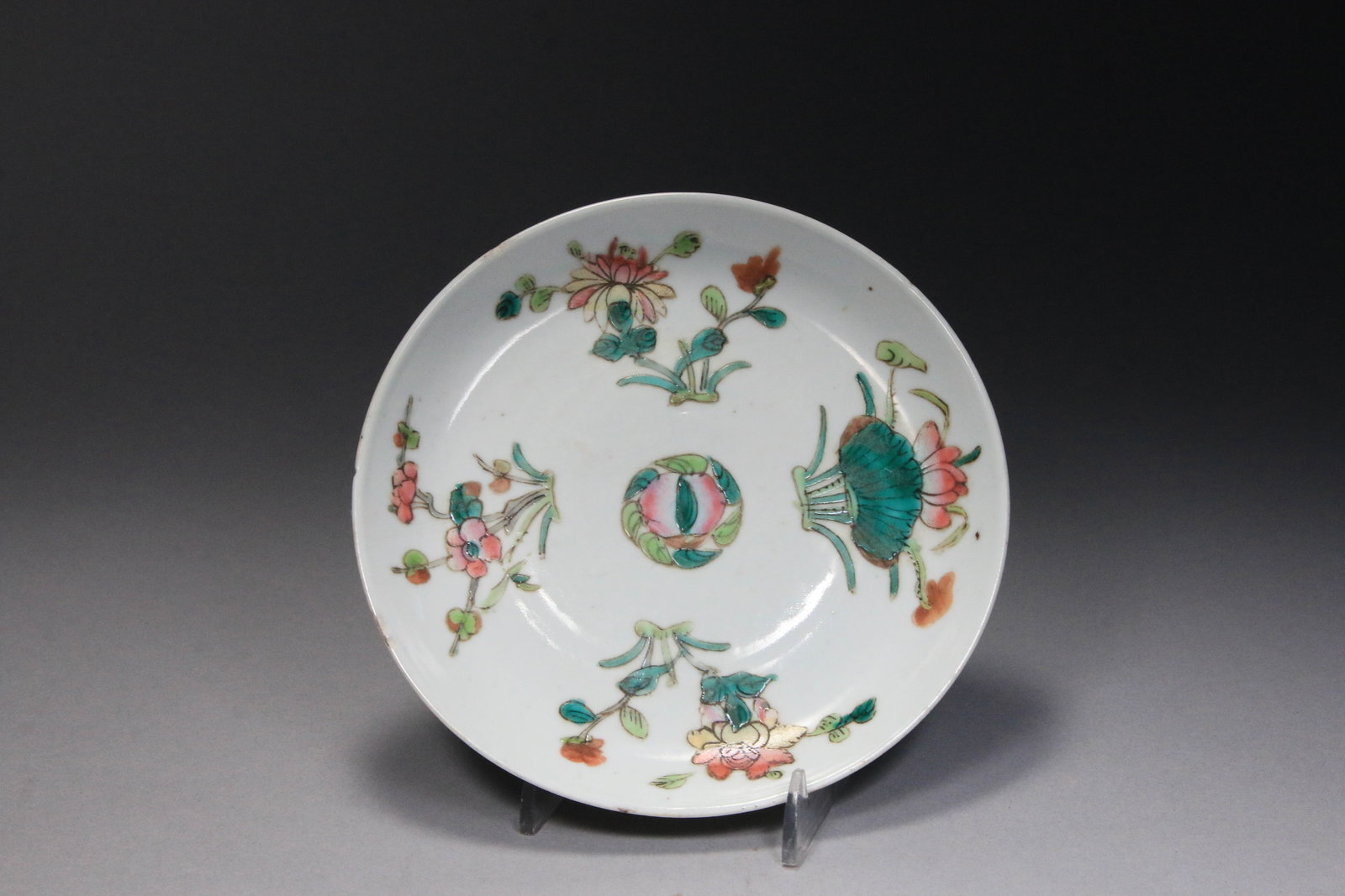 Chinese Famille Rose Porcelain Plate: Chinese Famille Rose plate that features a vibrant, hand-painted floral design, commonly referred to as the "four sprigs of flowers" pattern, which includes chrysanthemums, prunus blossoms, and lotus 