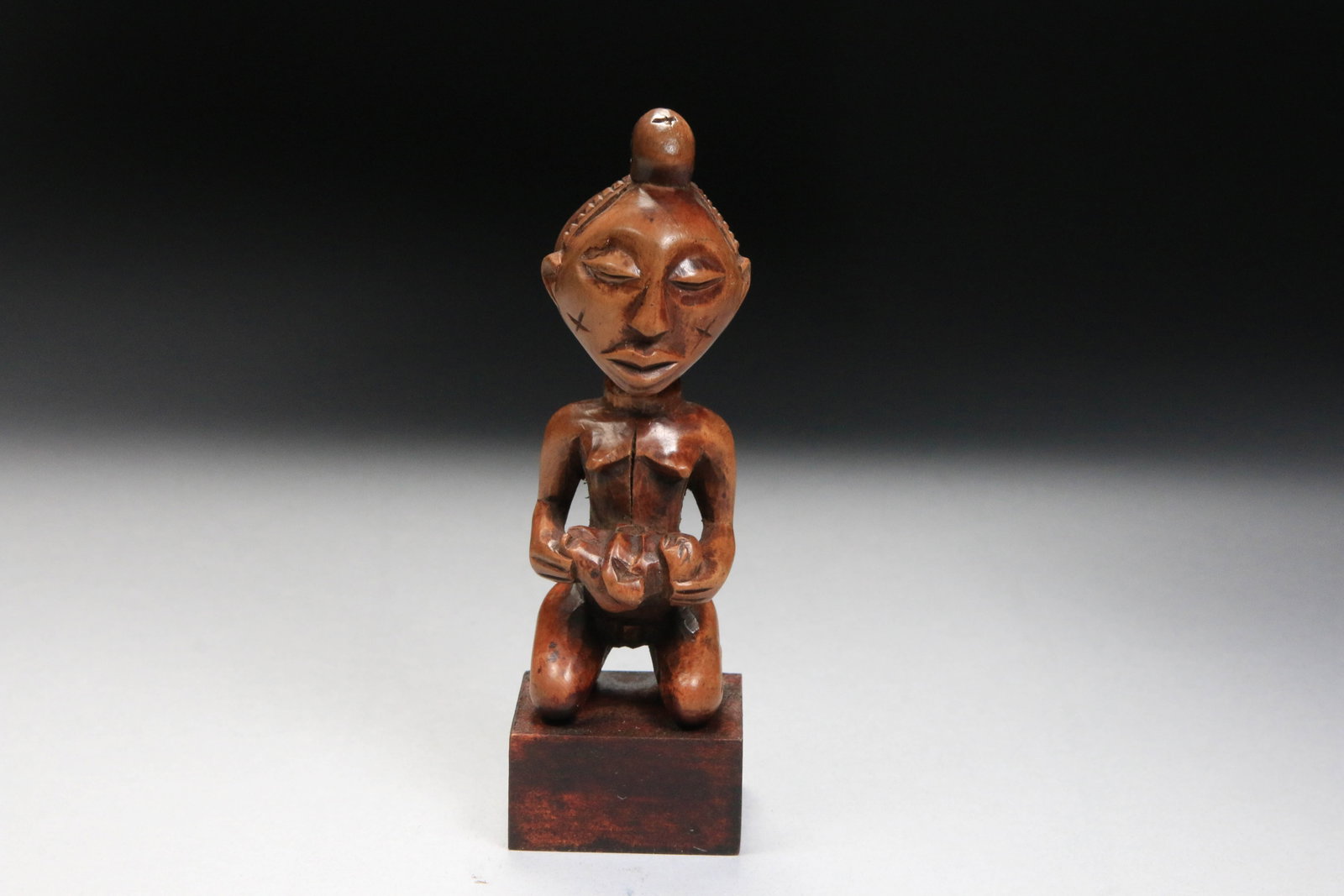 African Art Miniature Luba Statue: A wood Luba statuette maternity figure, Congo, on display stand. 4-1/2" H (w/o stand). Provenance: Ex. Collection Dr. Endicott, NYC.