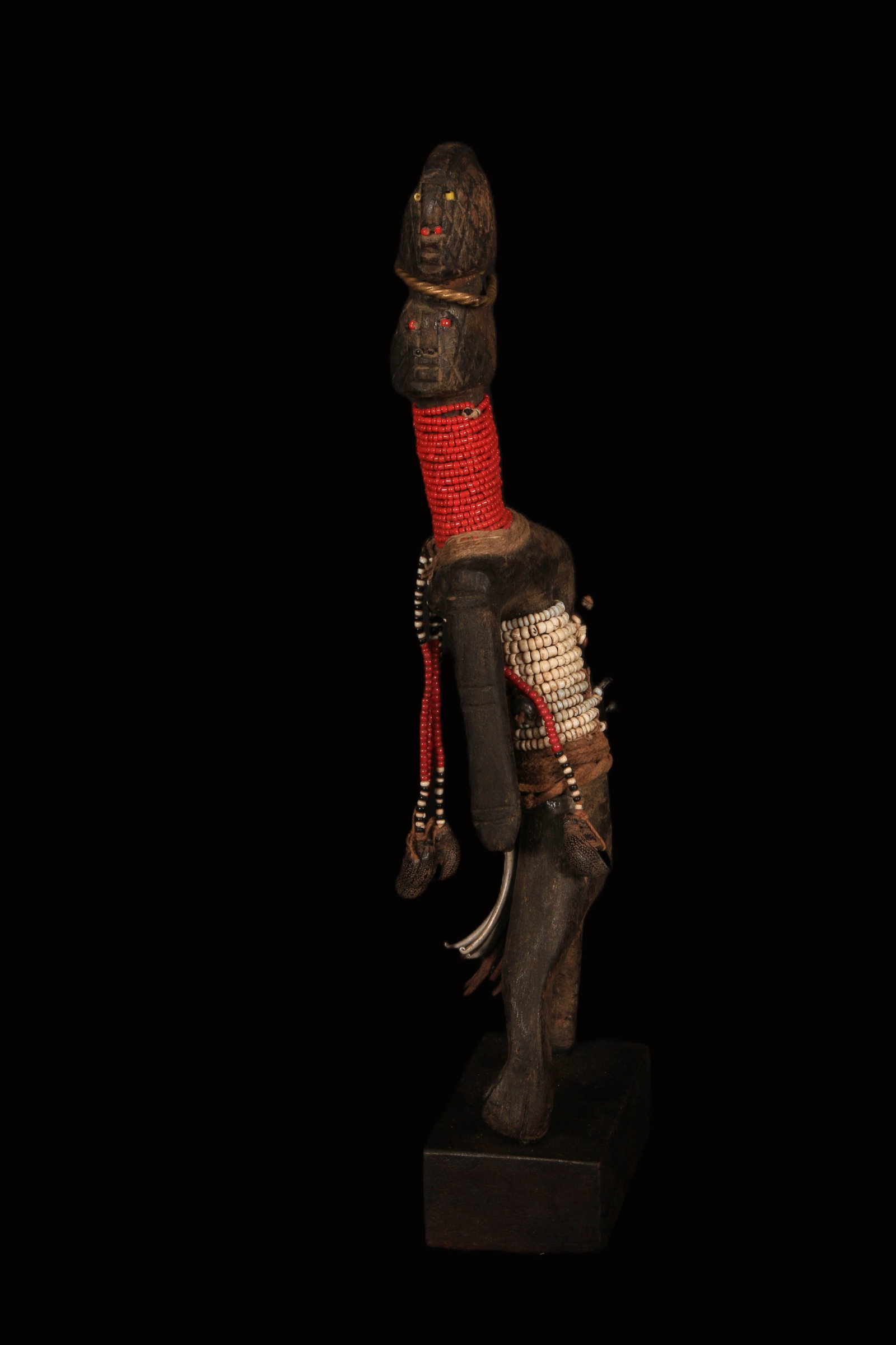 African Art Cross Border Charm: A wood and beaded fetish charm statue. 13" H. Provenance: Ex. Collection Leonard Kahan.