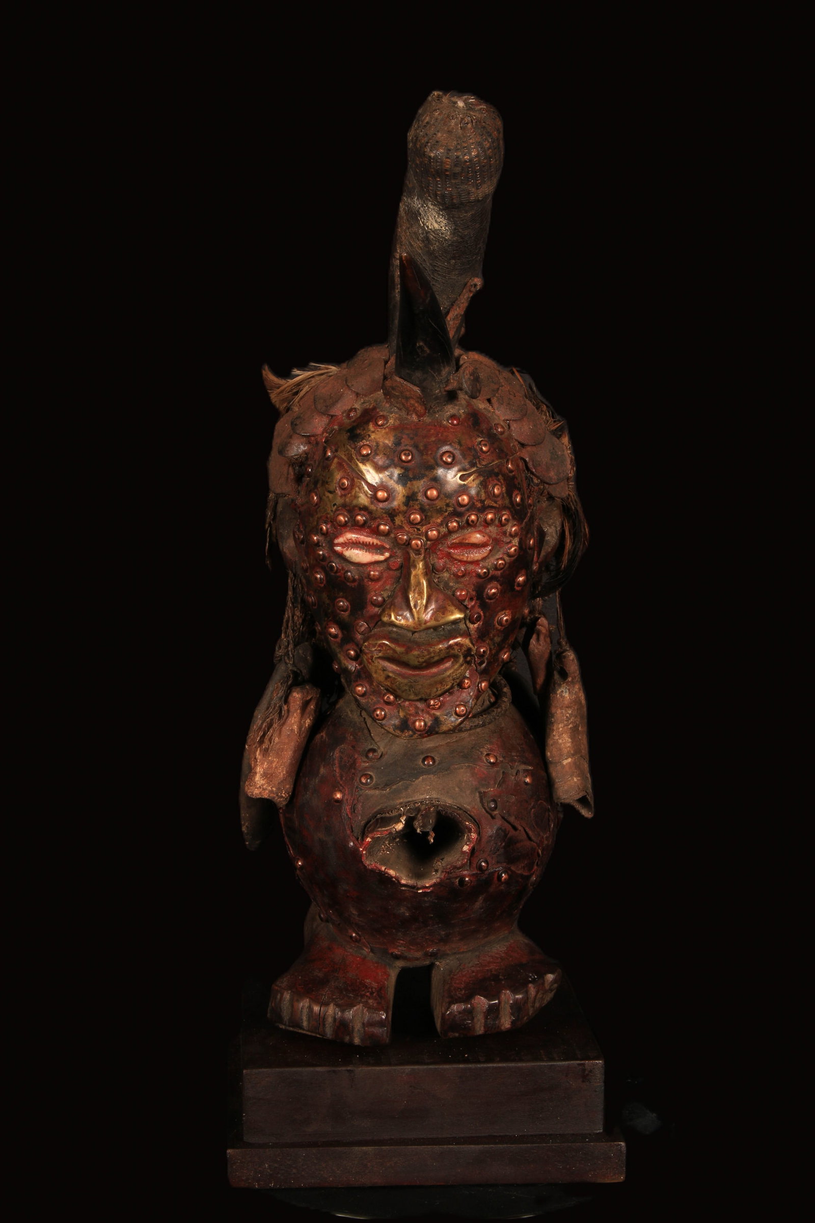 African Art Songye Fetish Figure: A Songye Nkishi power figure, Democratic Republic of Congo. Wood, metal, horn, feathers and a necklace of power charms. 16" H. Provenance: Ex. Collection D. Ackley, MD acquired from Allan Stone.