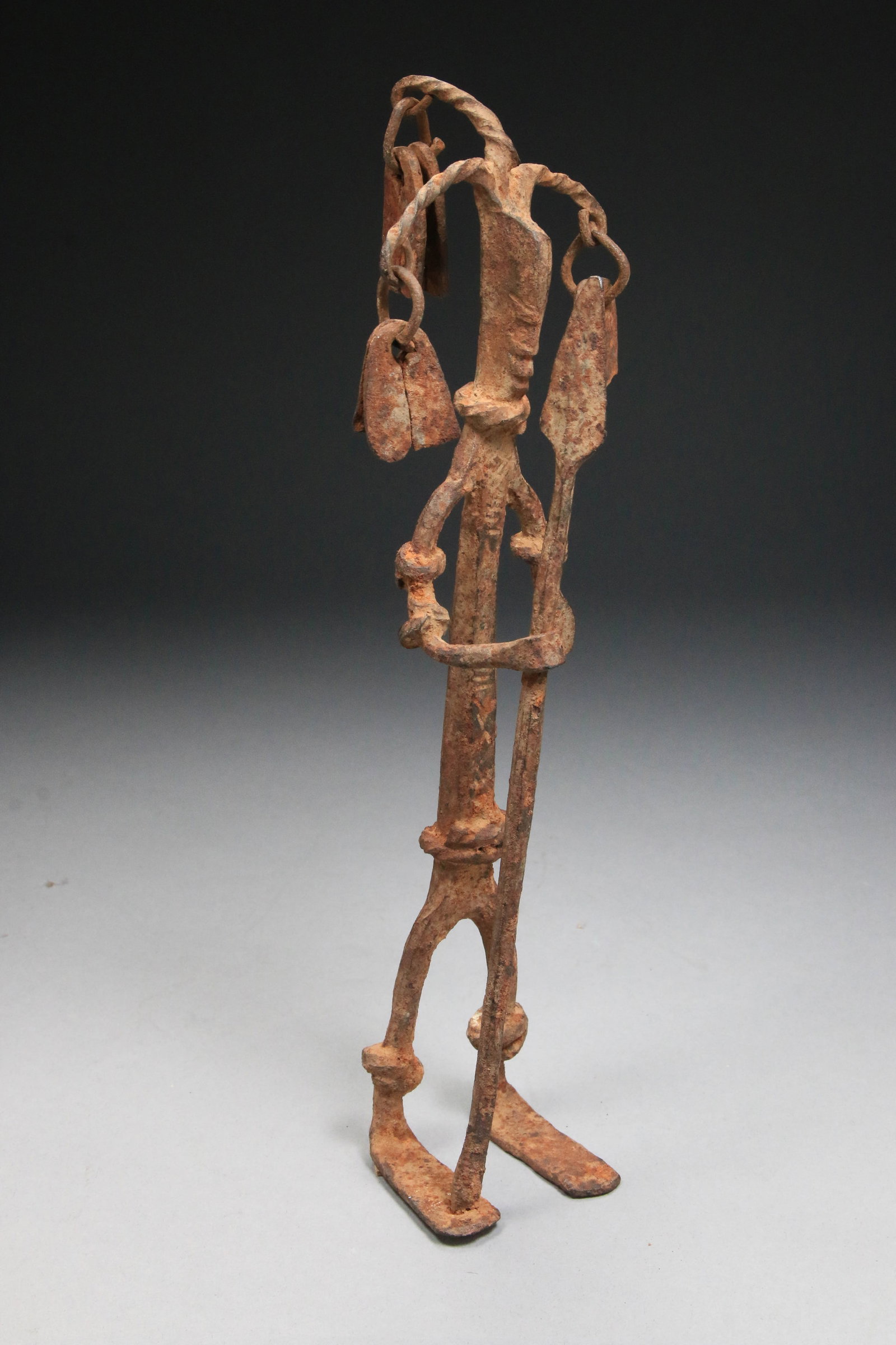 African Art Iron Figure - Dogon: Dogon hunter or warrior ritual statue holding a spear. 10-1/2" H. Provenance: Ex collection Ross Lance. Collection was commenced in the 1920's. Dogon warrior ritual statue from Mali, West Africa. Hand