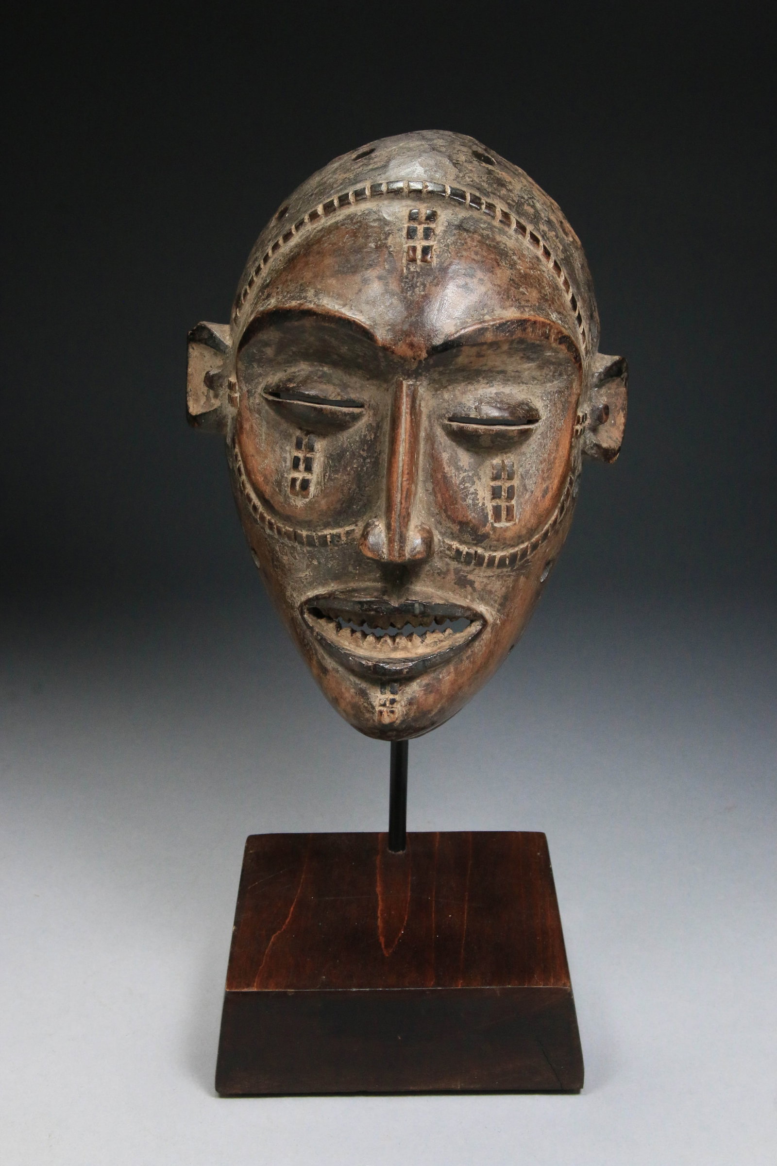 African Art Chokwe Mask - Angola: A wood Chokwe Mwana Pwo mask, a traditional wooden mask, Angola. 7-1/2" H x 5-1/2" W. This mask comes with a display stand. Provenance: Ex. collection Albert Stanzino. The mask represents an idealized