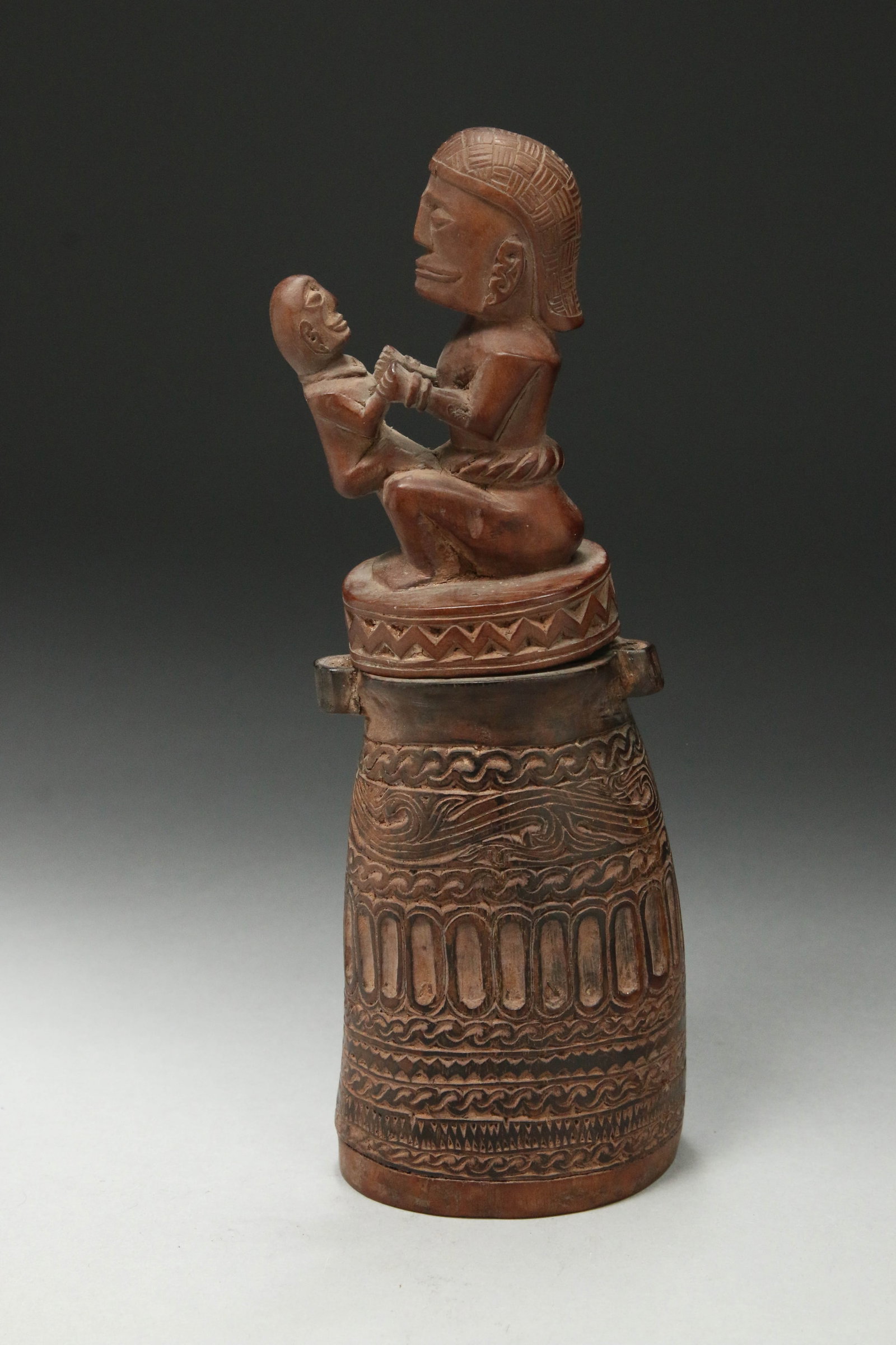 Indonesian Carved Herb Container: A carved horn and wood herb container with mother and child finial. 7-3/4" H