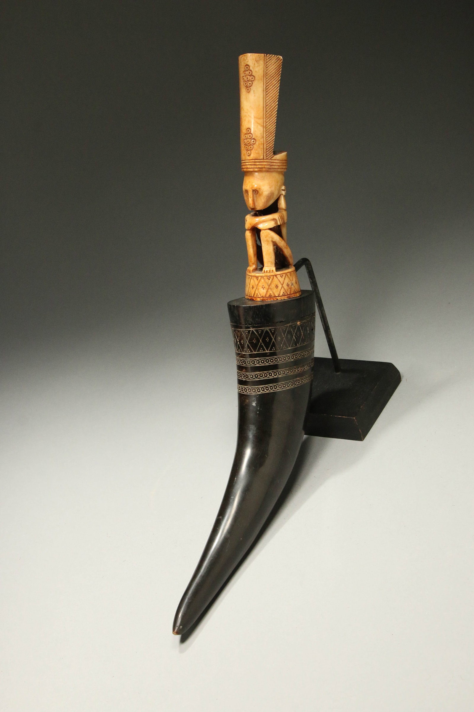 Indonesian Horn and Bone Medicine Container: A large herbal medicine container, body made of horn, incised design, top is a bone carved figure as stopper. 16" L