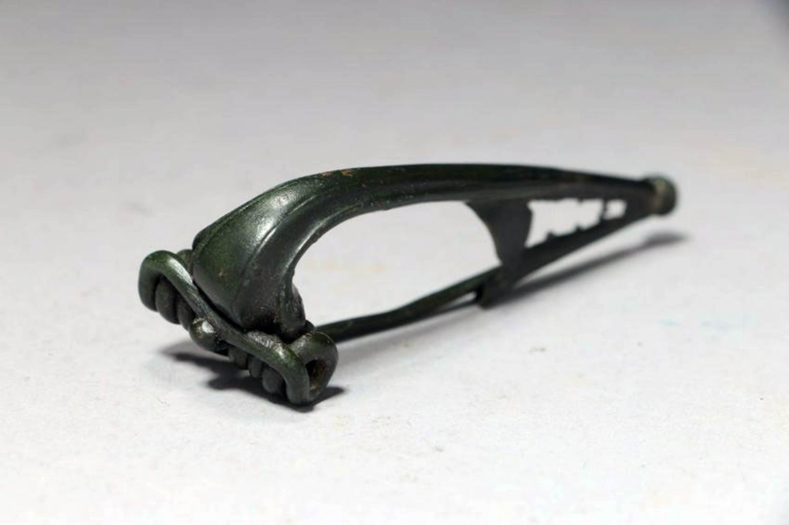 Ancient Roman Fibula: A bronze fibula 200 A.D., with working pin. 3" L Great patina. Ex UK collection