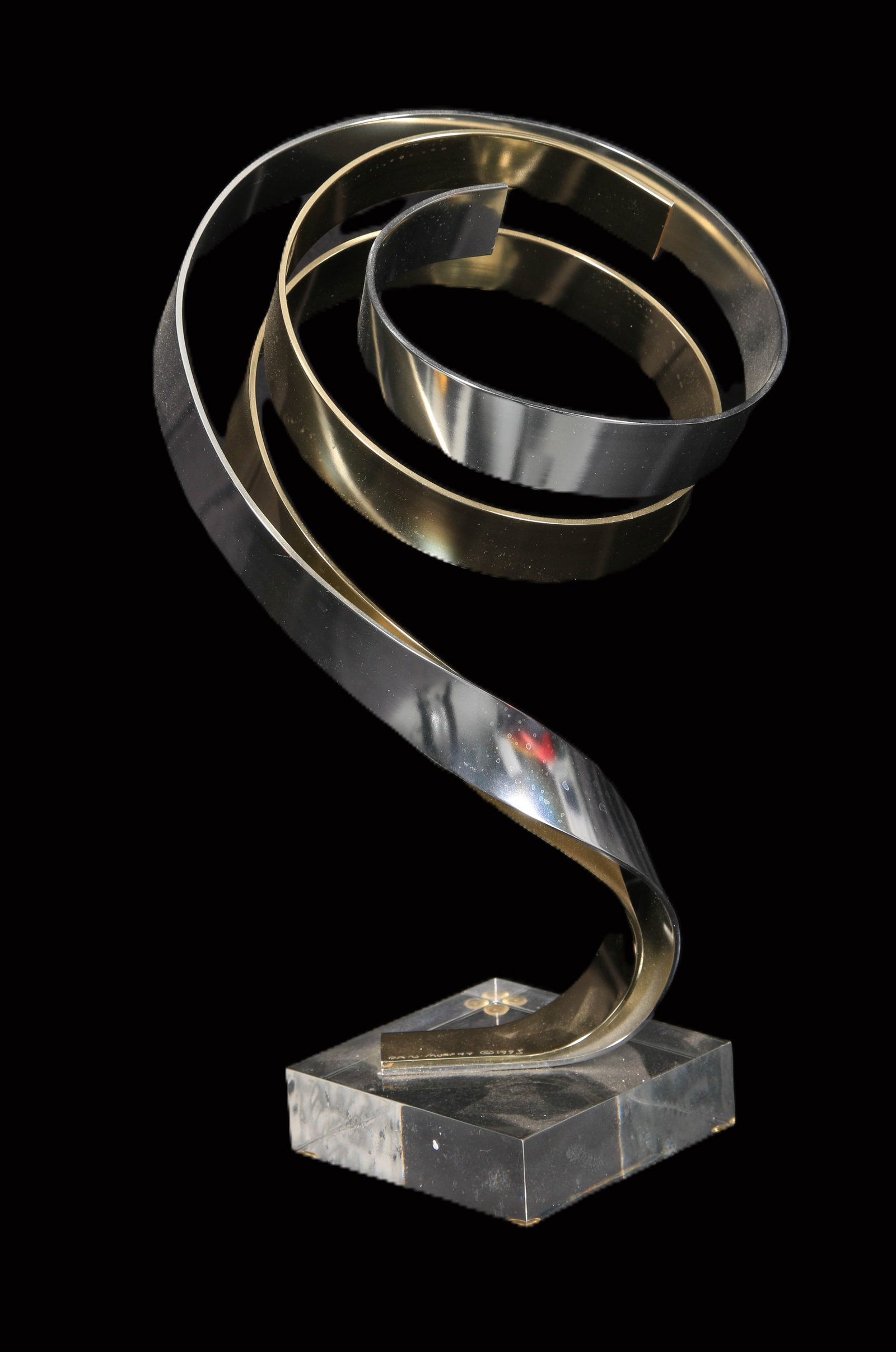 Dan Murphy (American, 20th C.), Spiral Metal Sculpture: Spiral metal sculpture on Lucite base, mixed metals intertwine into upward spiral form, c. 1995, signed on metal at base.. 12 1/4" H.