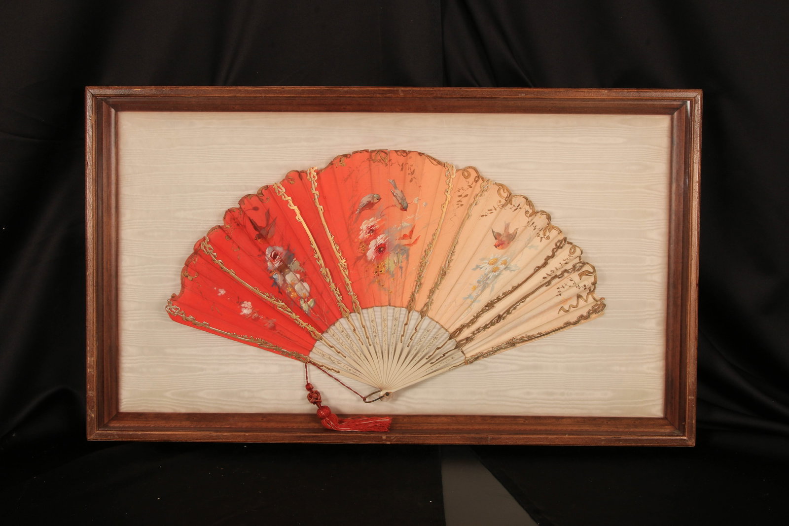 19th Century Hand-Painted Fan with Tassel: A hand-painted silk fan, featuring a floral and bird design. It features a tassel with mother-of-pearl sticks mounted in a shadow box, Victorian era. 33" x 19".