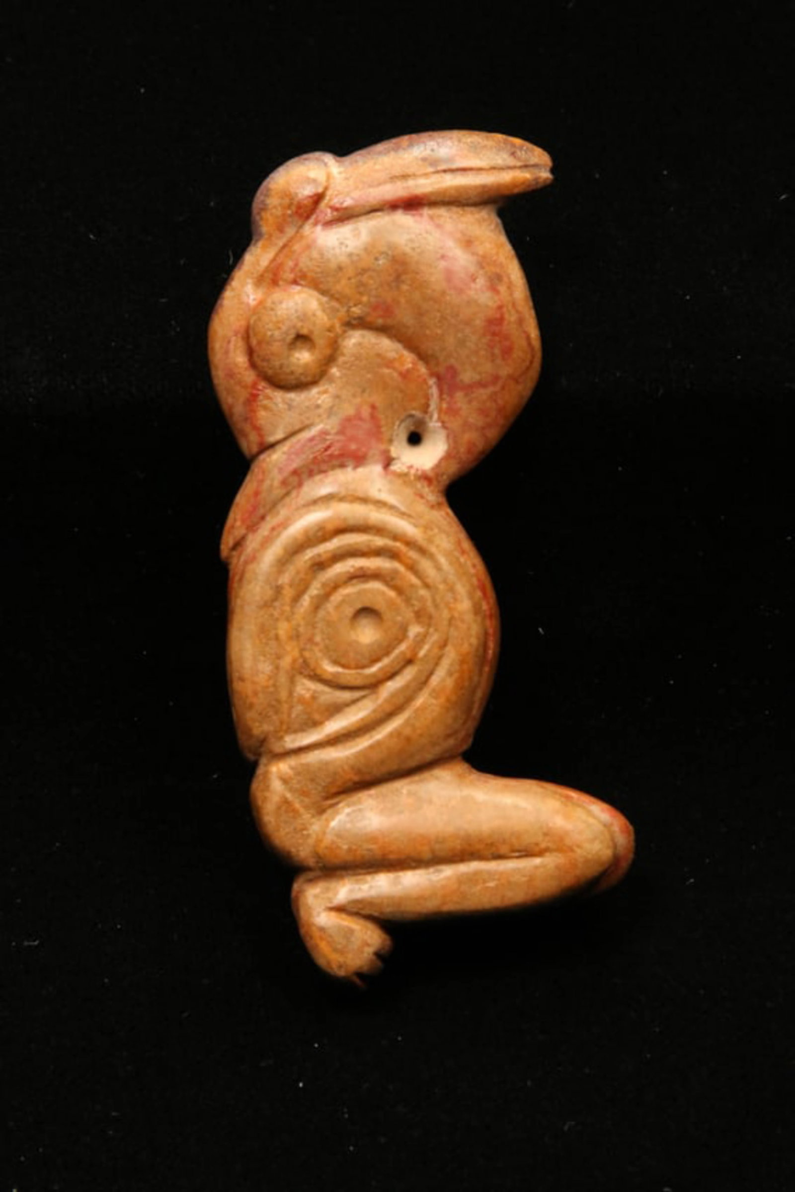 Pre-Columbian Stone Bird Amulet: A Taino stone amulet of a bird with a pelican beak, remains of red pigmentation. Suspension hole. 3-1/2" L. Provenance: Ex collection Tony Milton, NM.