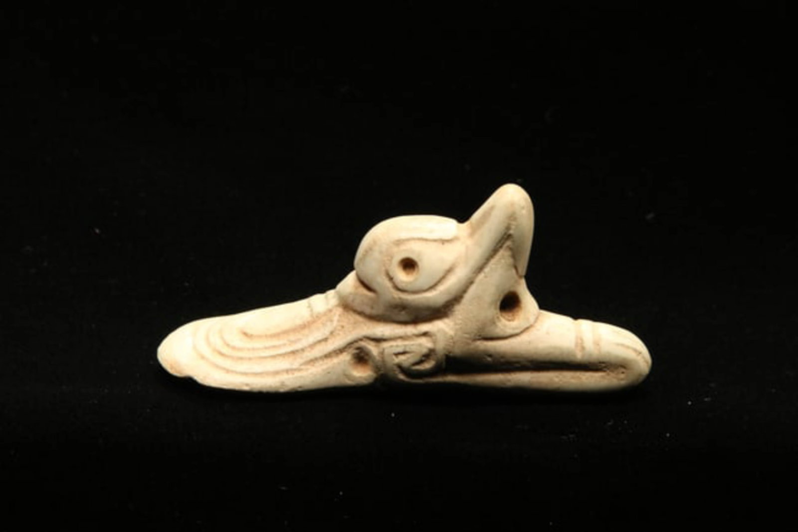 Pre-Columbian Stone Amulet: A Taino stone amulet of a bird with suspension holes. 3" L. Provenance: Ex collection Tony Milton, NM.