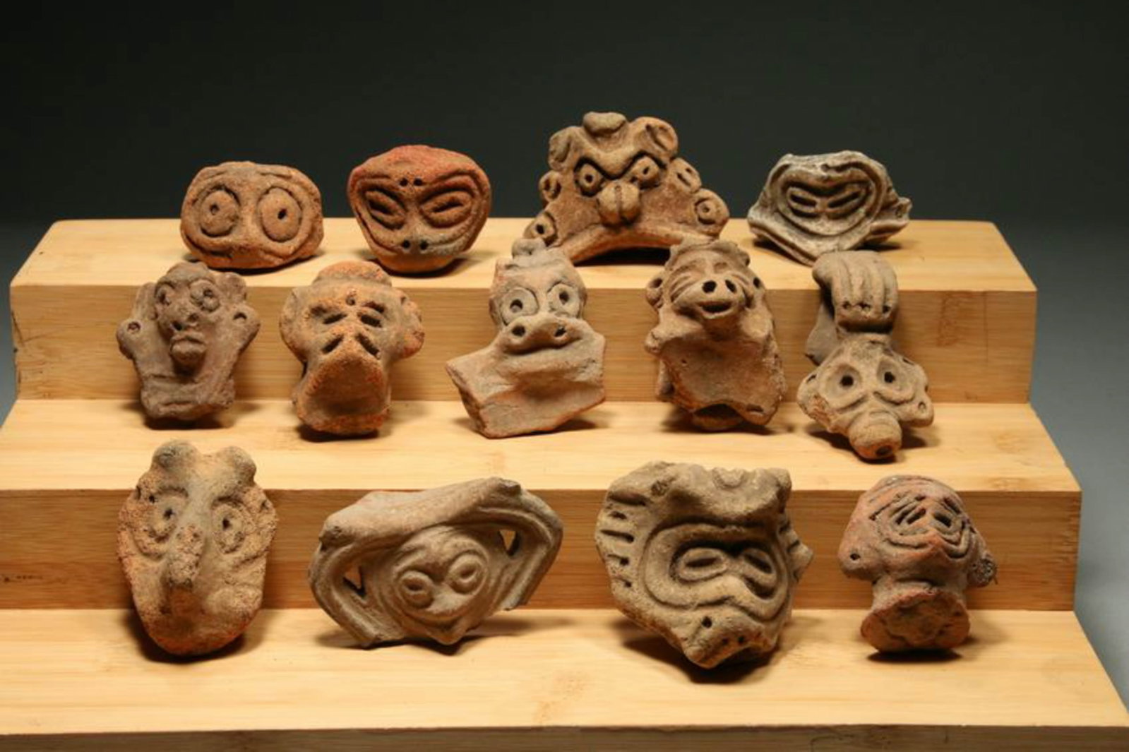 Pre-Columbian Ta?no pottery fragments - Adornos: Taino zoomorphic terracotta head fragments (Adornos), lot of 13, various sizes 2" L to 2-3/4" L. The faces shown depict various subjects, including bats, deities, and ancestor spirits, showcasing care