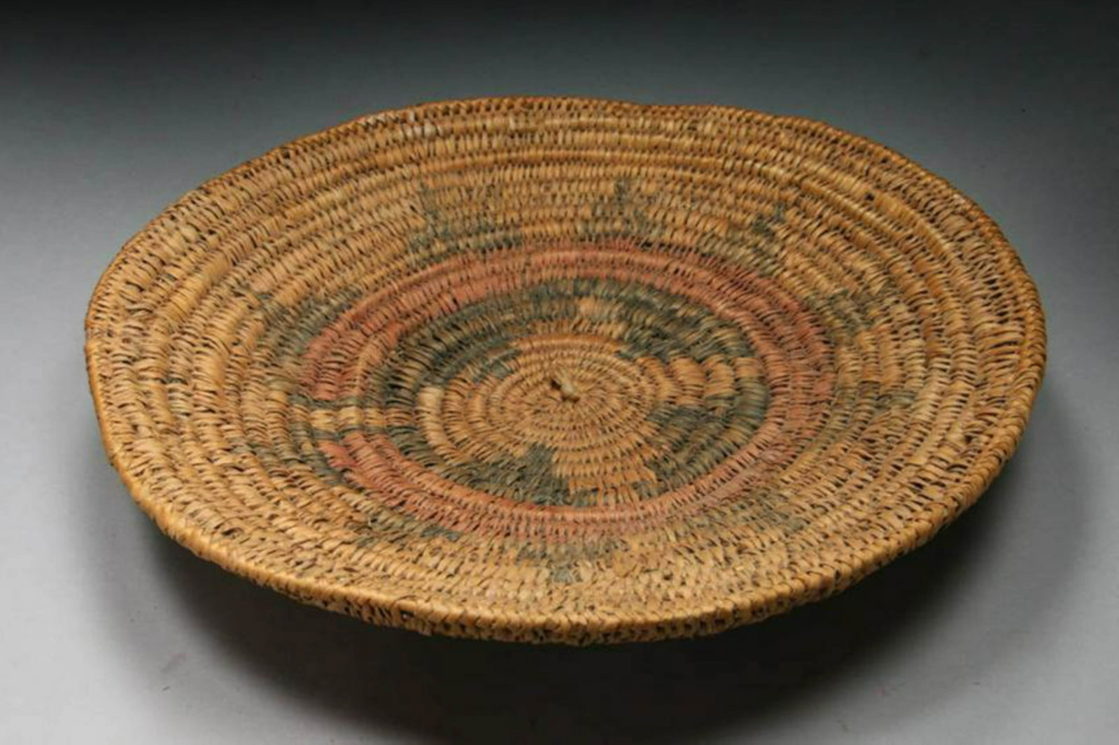Native American - Wedding Basket - Navajo: A large shallow weaved basket, sun design in center. 12-3/4" Dia x 1-1/2" H. Handwoven Navajo wedding basket is made using traditional two-rod and bundle techniques with sumac and yucca fibers. These