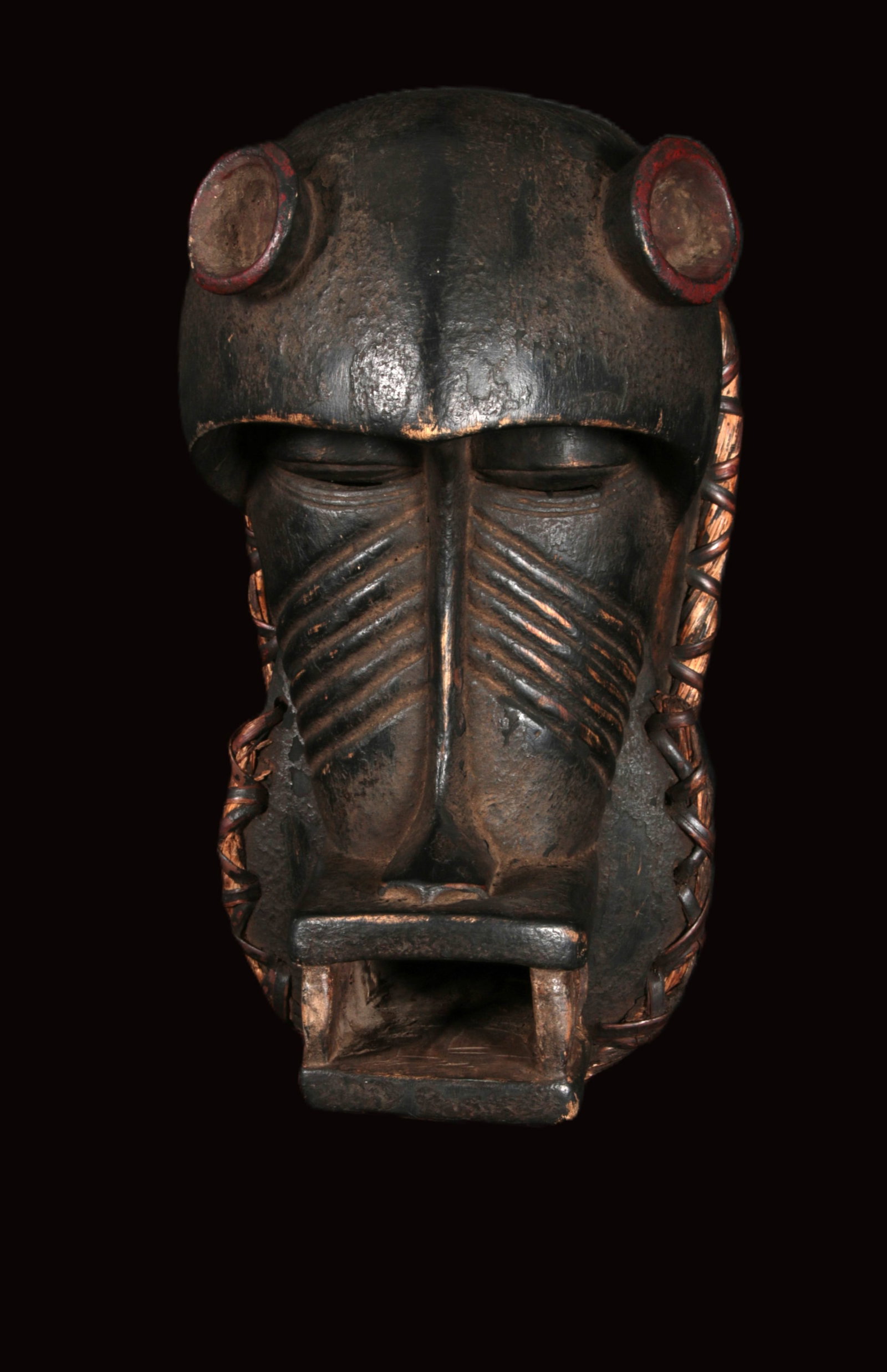 African Art Baule Helmet Mask: A Baule zoomorphic helmet mask, Ivory Coast. ) This zoomorphic sculpture represents a powerful and dangerous bush spirit (Asie Usu). It is characterized by its heavy, dome-like forehead, deep-set slit