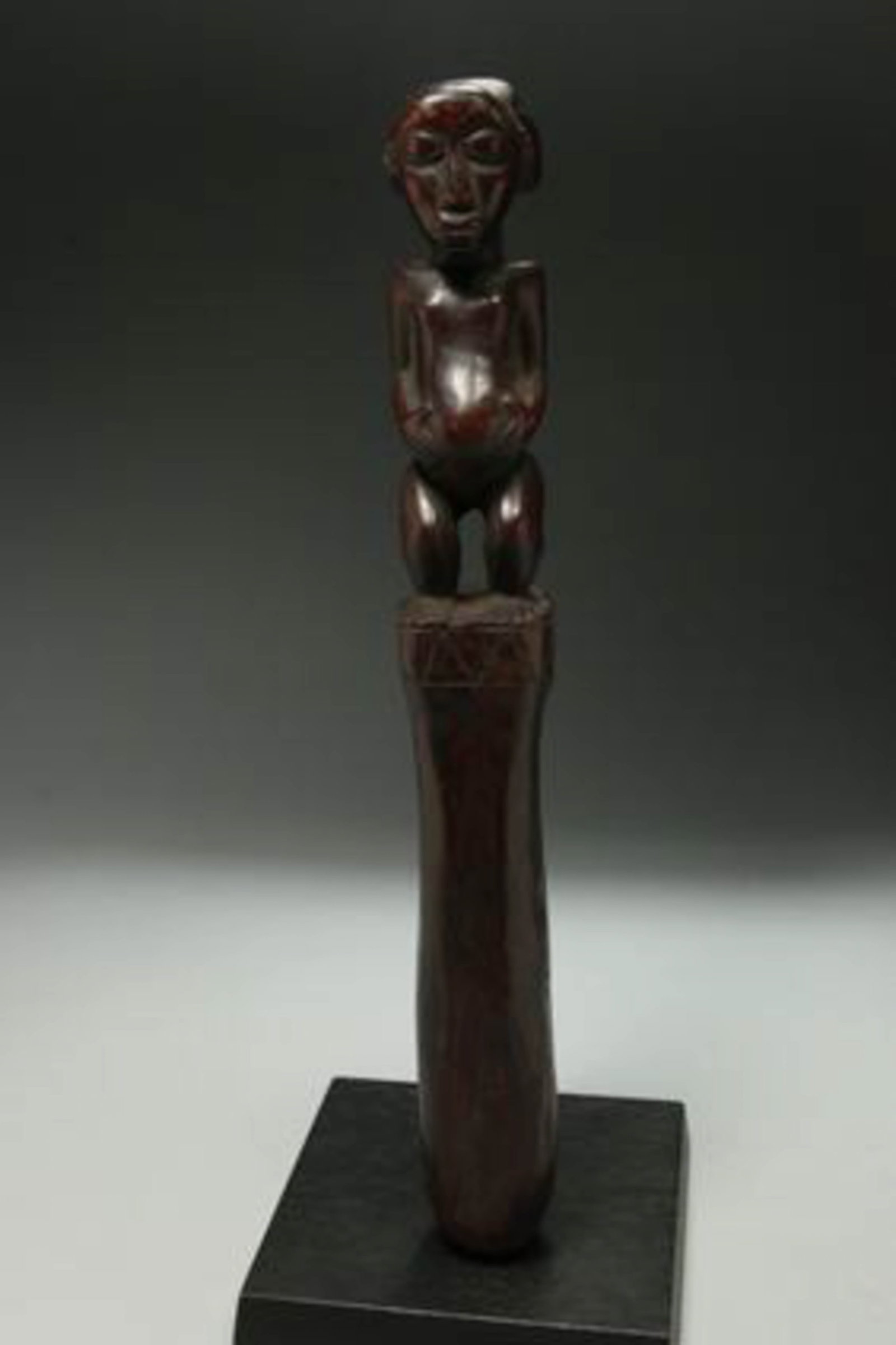 African Art Hemba Pounder: A wood staff pounder with carved male finial. 14" H Provenance: Ex Columbia University Professor