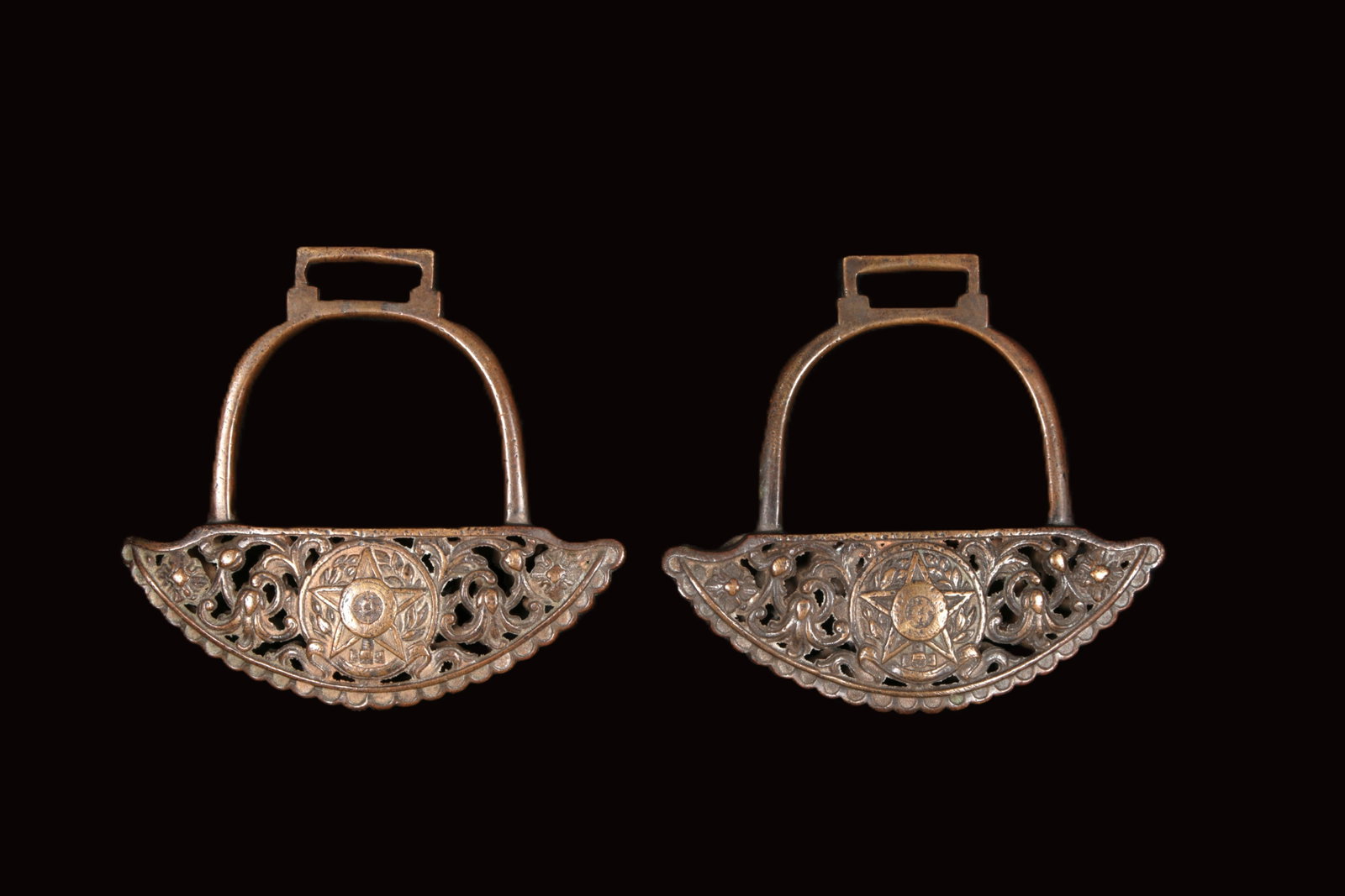 19th Century Spanish Stirrups: A pair of 19th C Bronze stirrups, reticulated with ornate foliate design, coat of arms in center. 9_1/2" L.