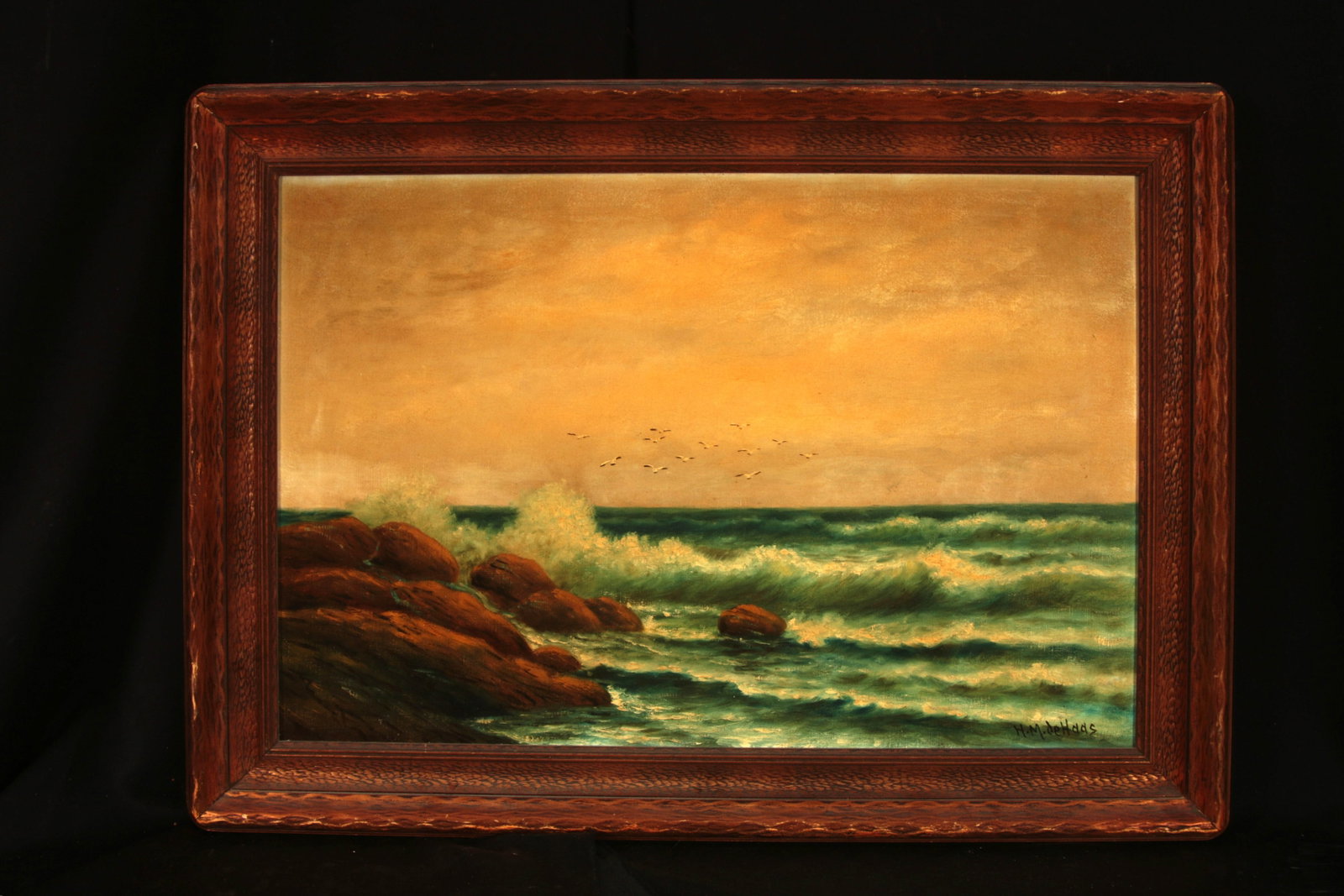 19th Century Oil on Canvas - Seascape signed Attributed to H.M. de Haas: An oil on canvas seascape of churning green and turquoise waves crashing against a dark, craggy boulders along the shoreline with seagulls in flight. 36" x 26". Signed lower right.